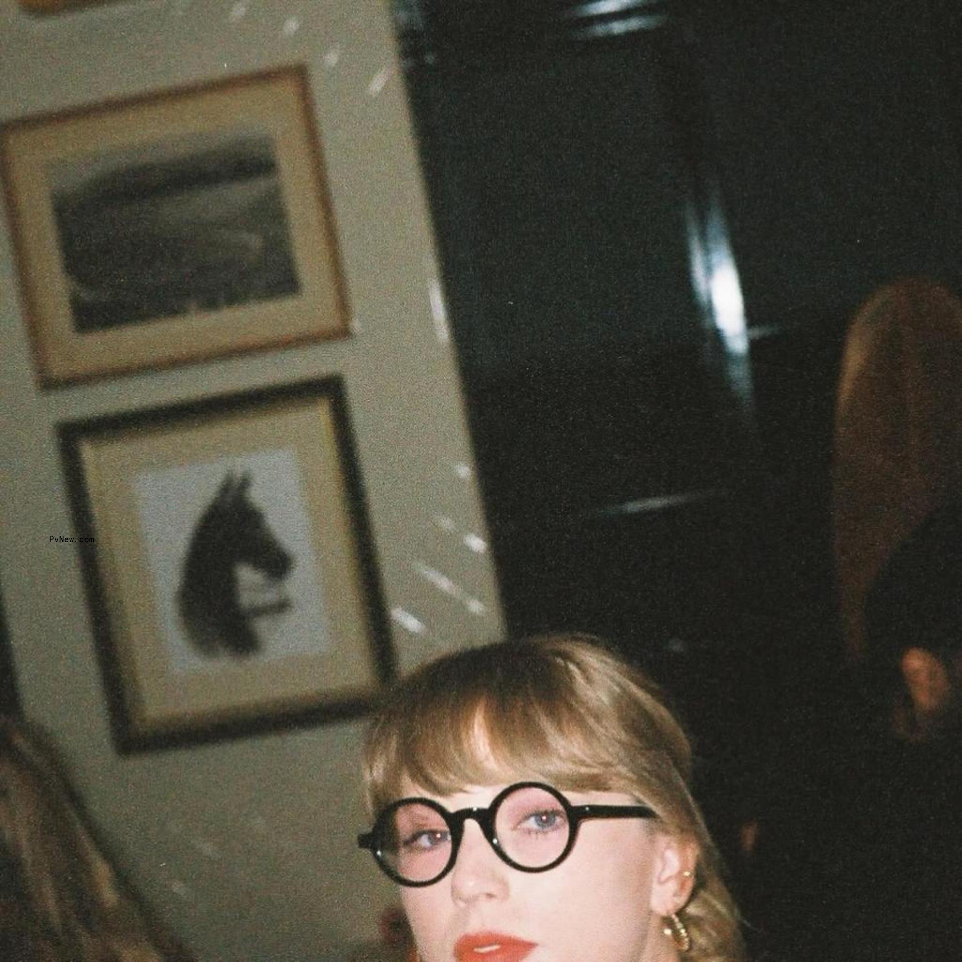 Taylor Swift wearing Jack Antonoff's glasses.