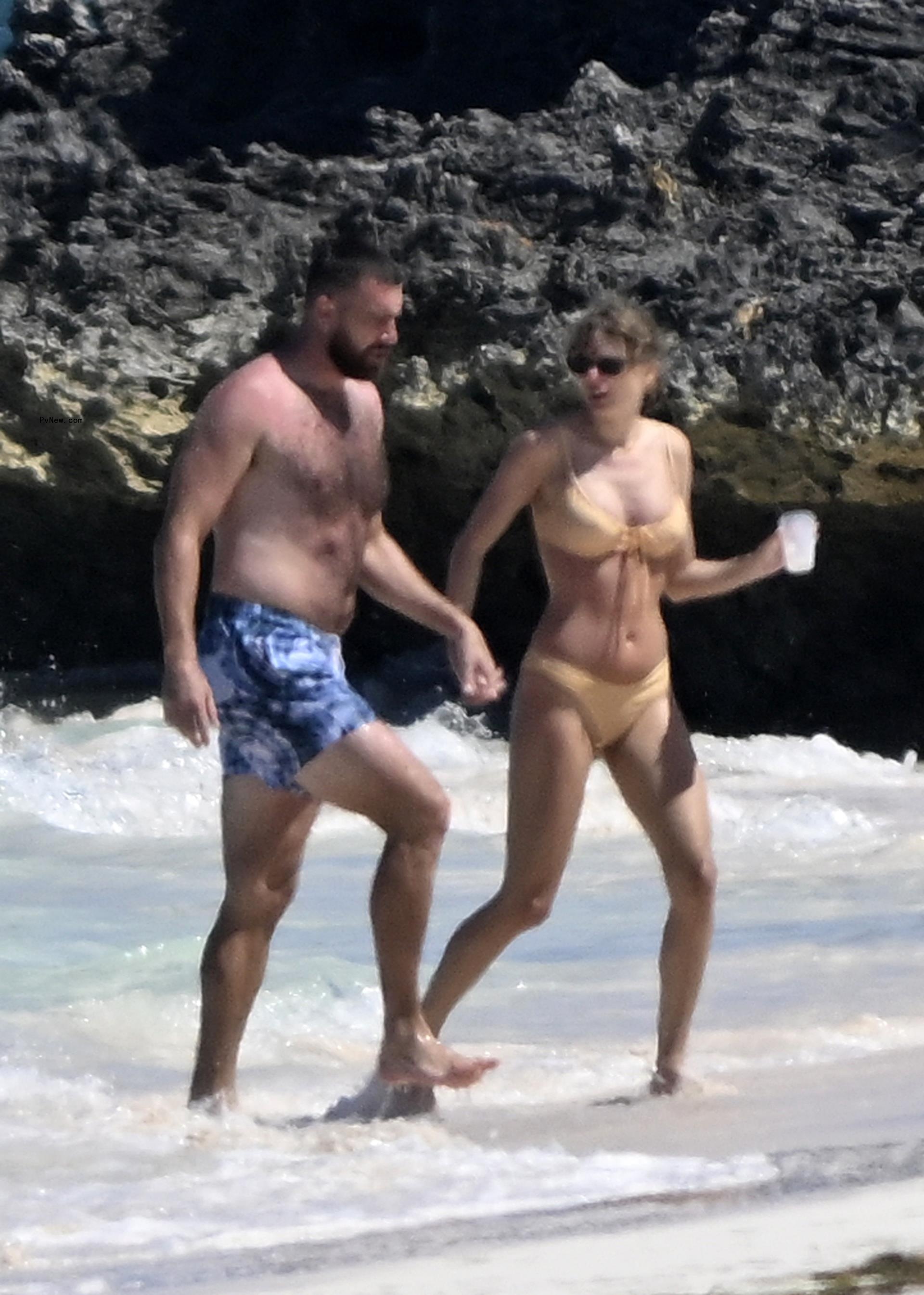 Travis Kelce and Taylor Swift at the beach.