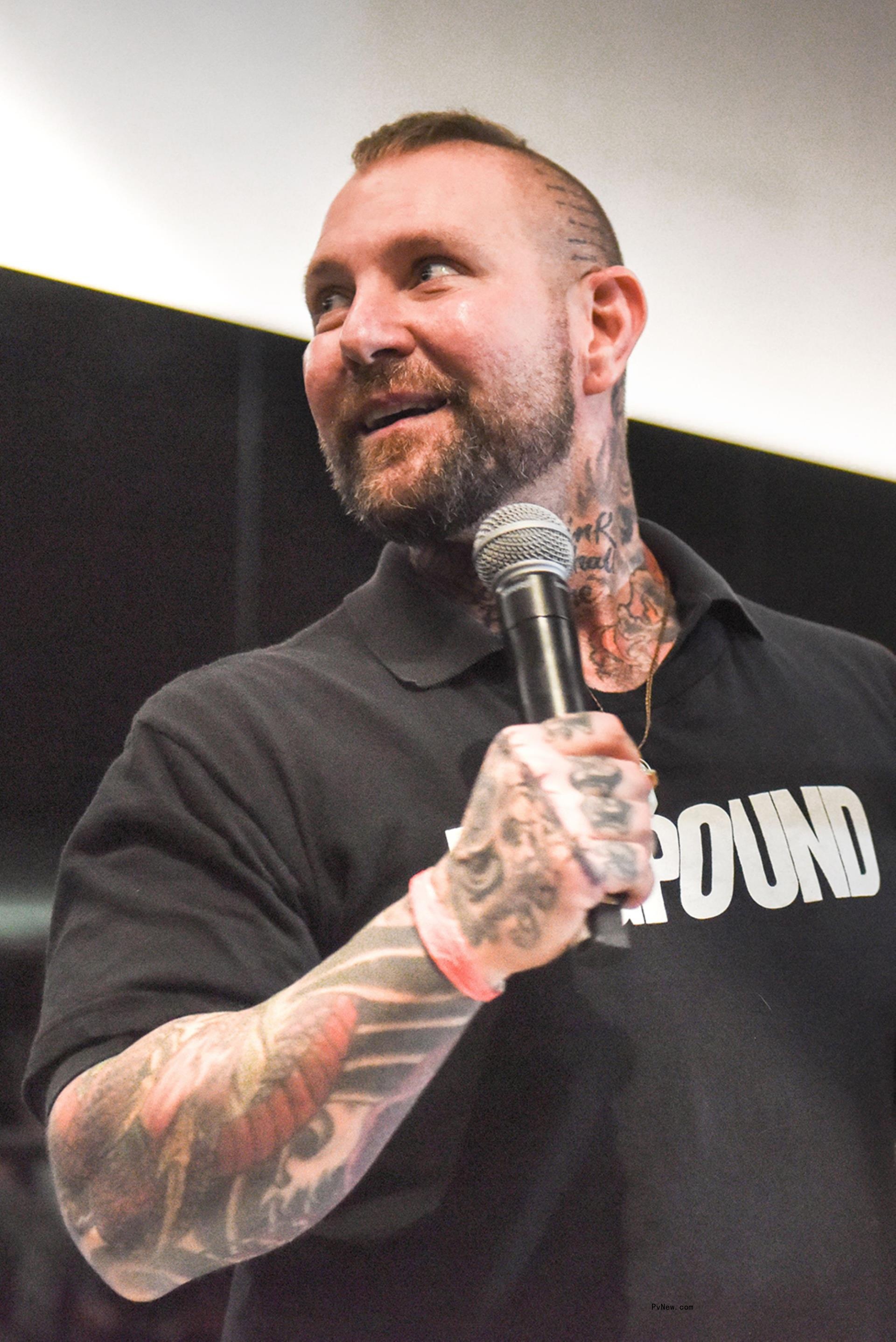 Kirk Myers holding a mic.