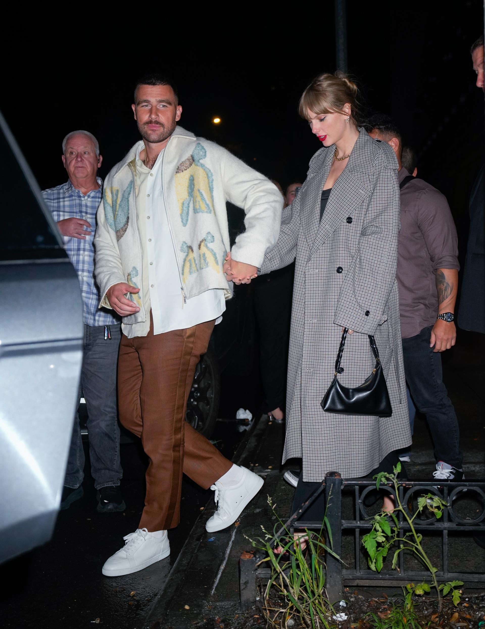 Travis Kelce and Taylor Swift walking