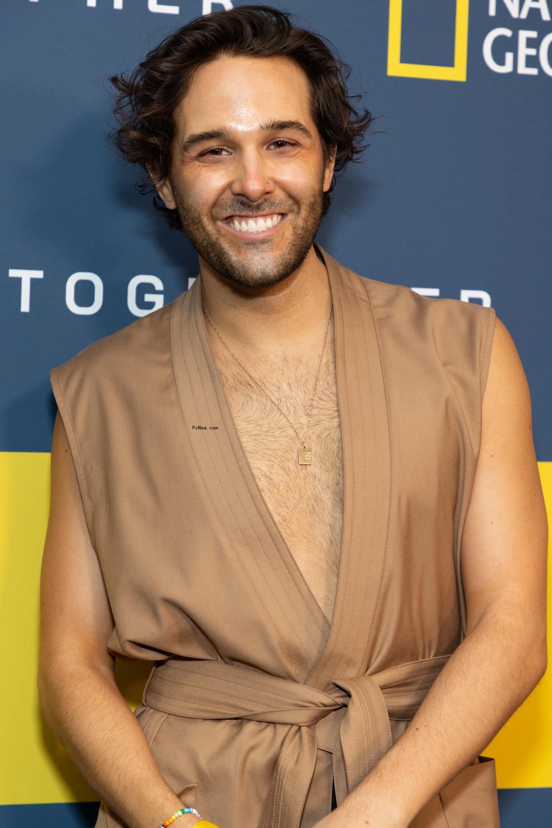 Tyler Co<i></i>nroy posing on a red carpet.