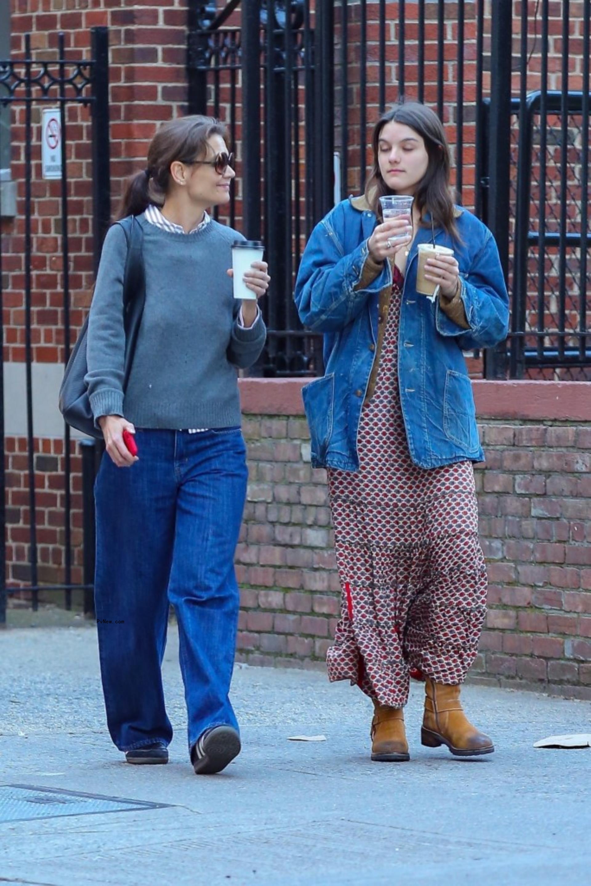 Katie Holmes and Suri Cruise walking with coffee in New York City.