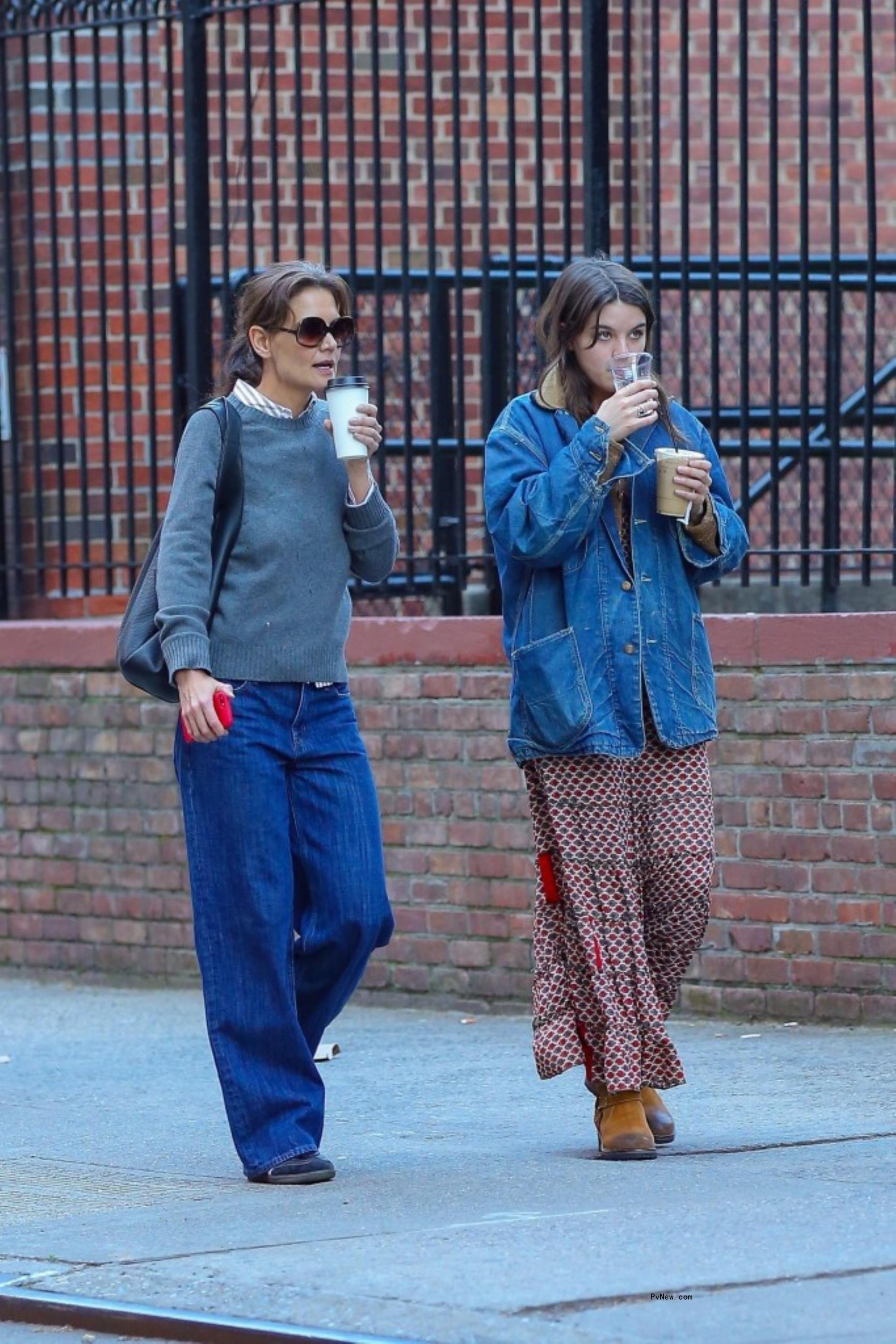 Katie Holmes and Suri Cruise walking with coffee in New York City.