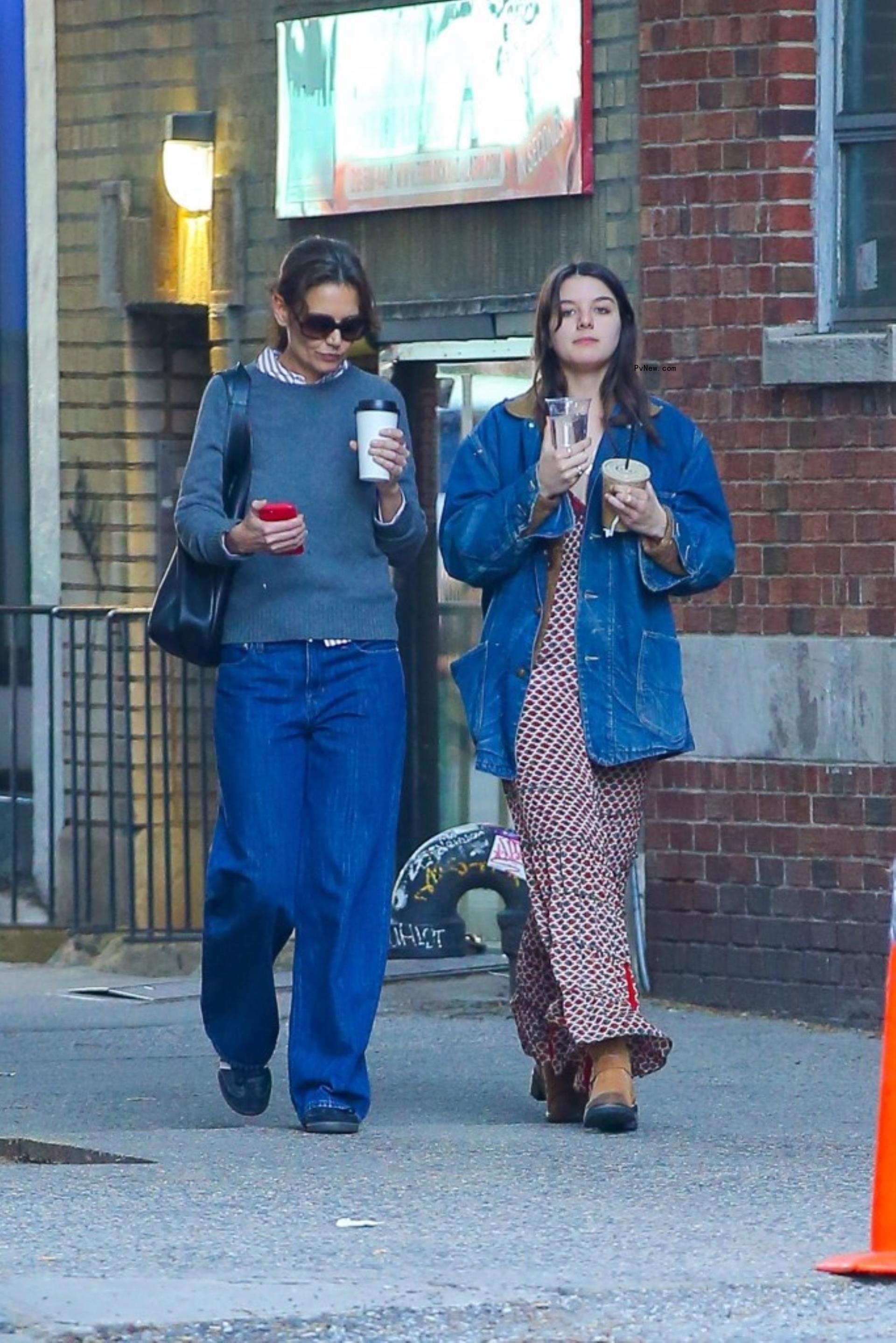 Katie Holmes and Suri Cruise walking with coffee in New York City.