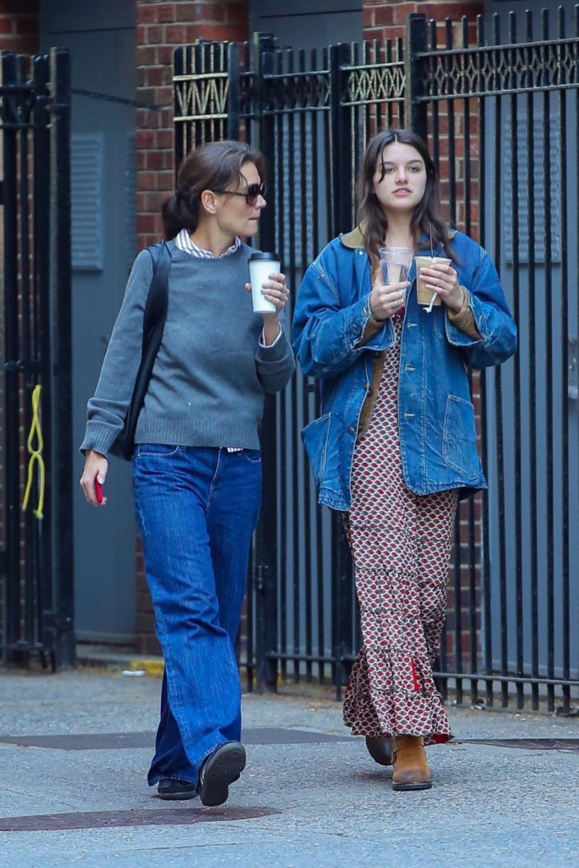 Katie Holmes and Suri Cruise walking with coffee in New York City.