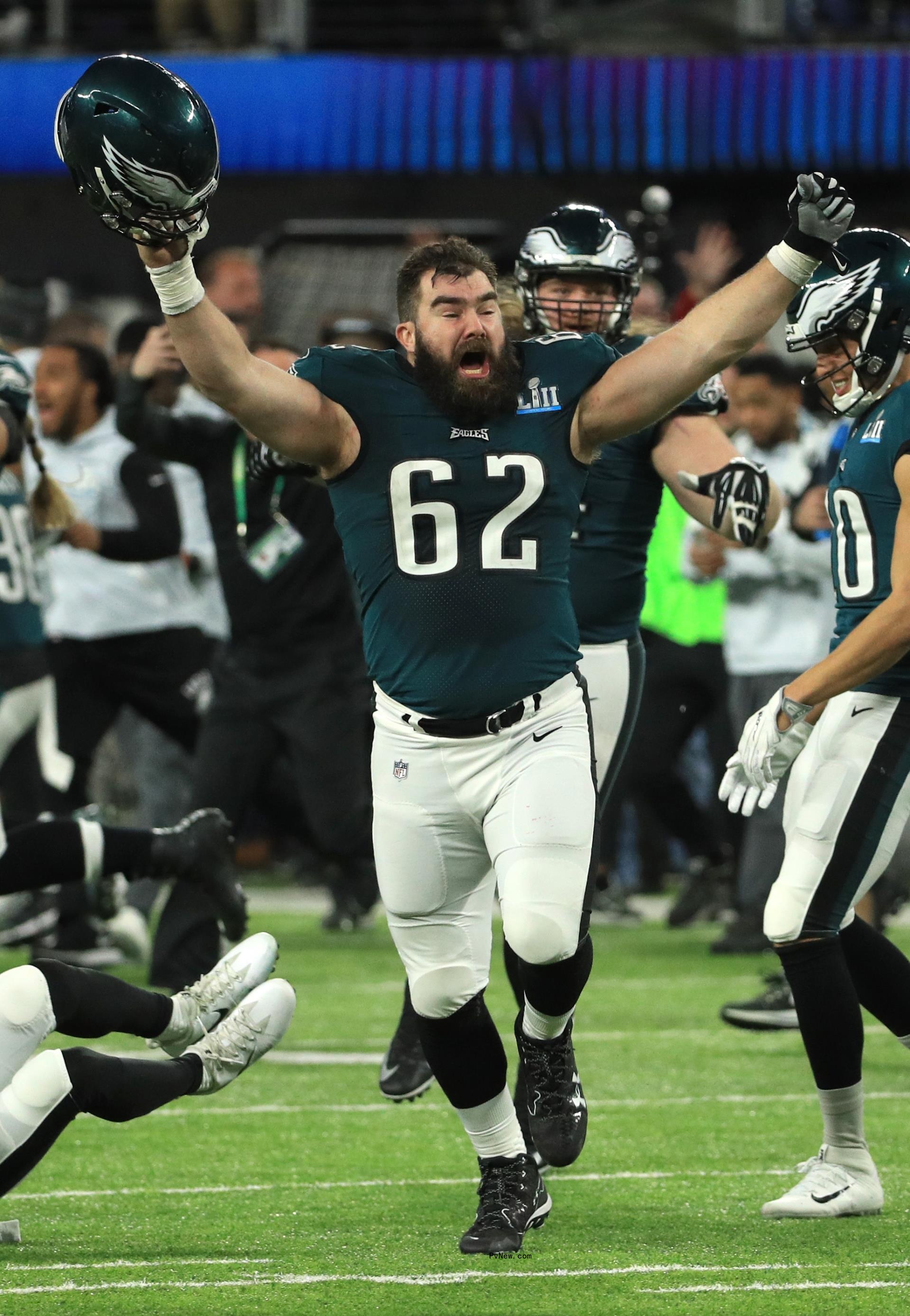 Jason Kelce running and cheering on a football field.