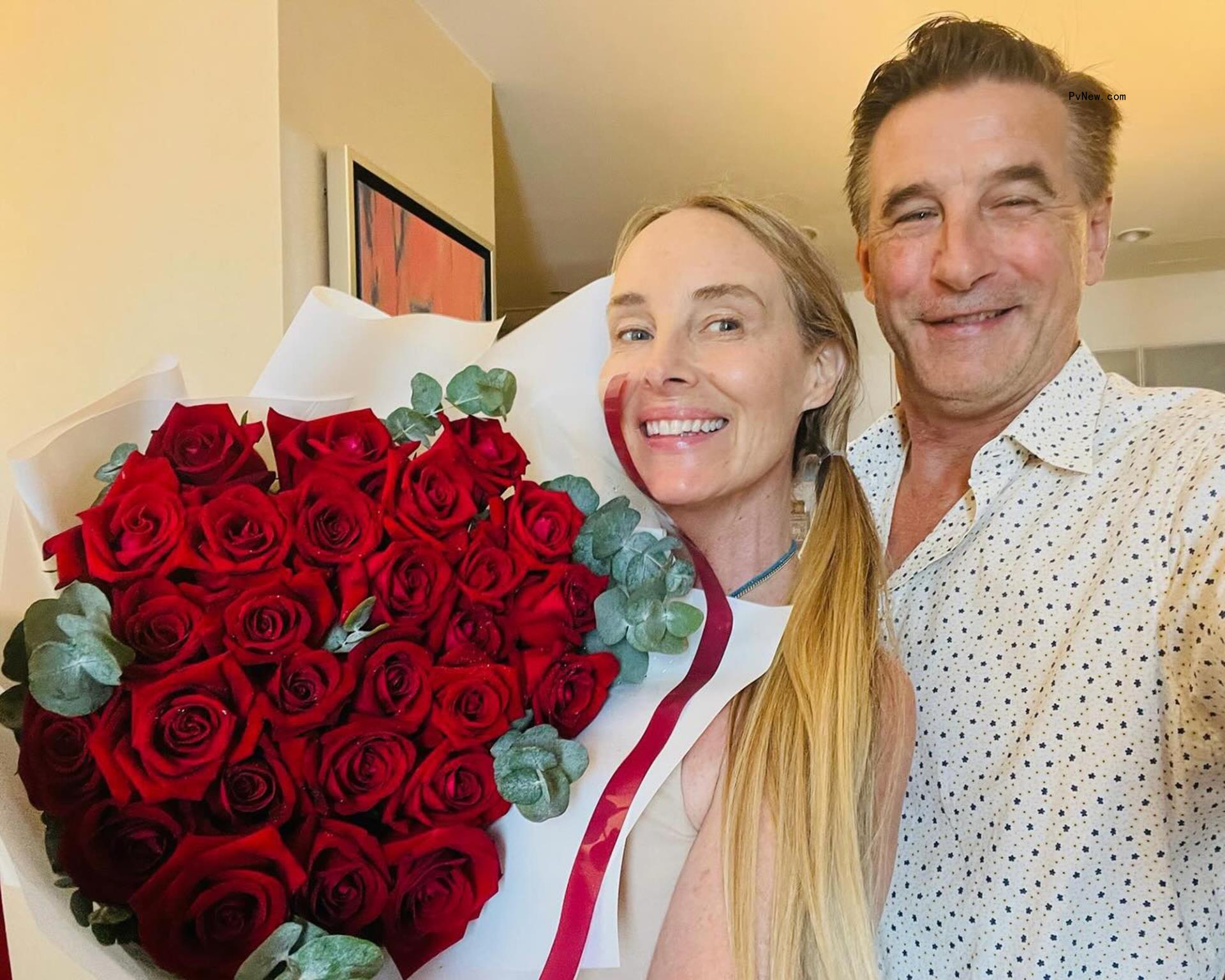 billy baldwin and Chynna phillips selfie with a big bouquet of roses