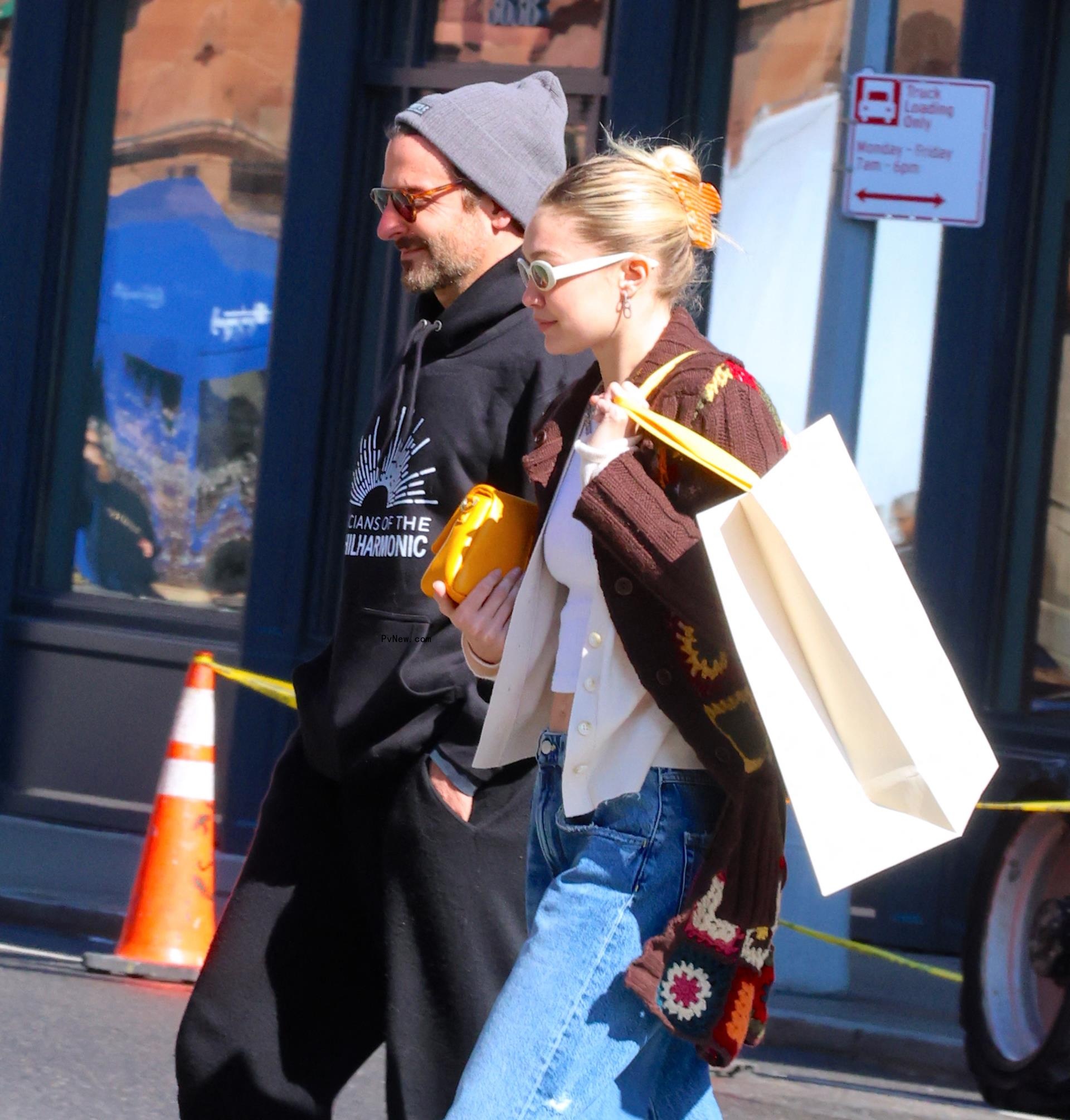 Gigi Hadid and Bradley Cooper walking.