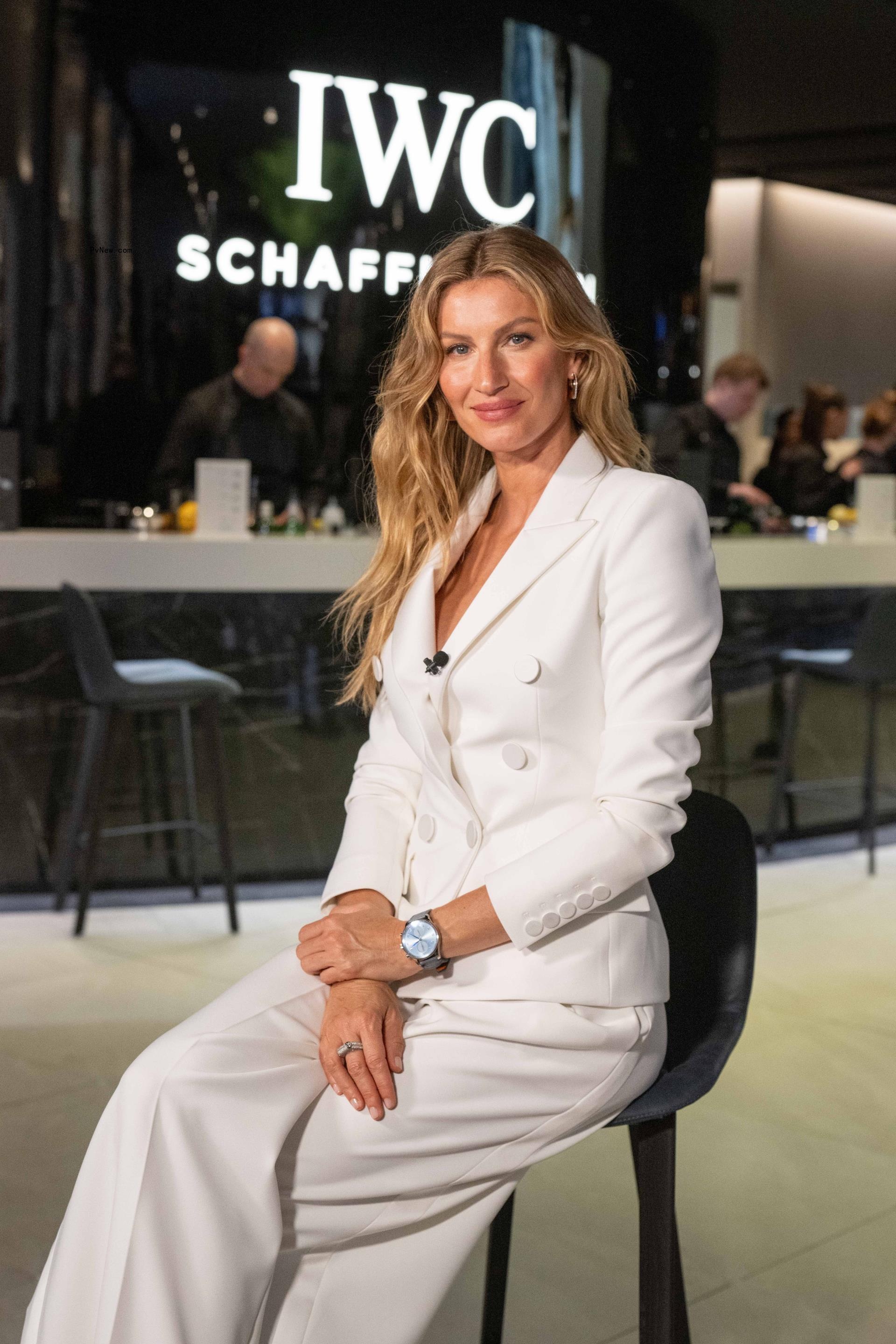 Gisele Bündchen in a white suit.