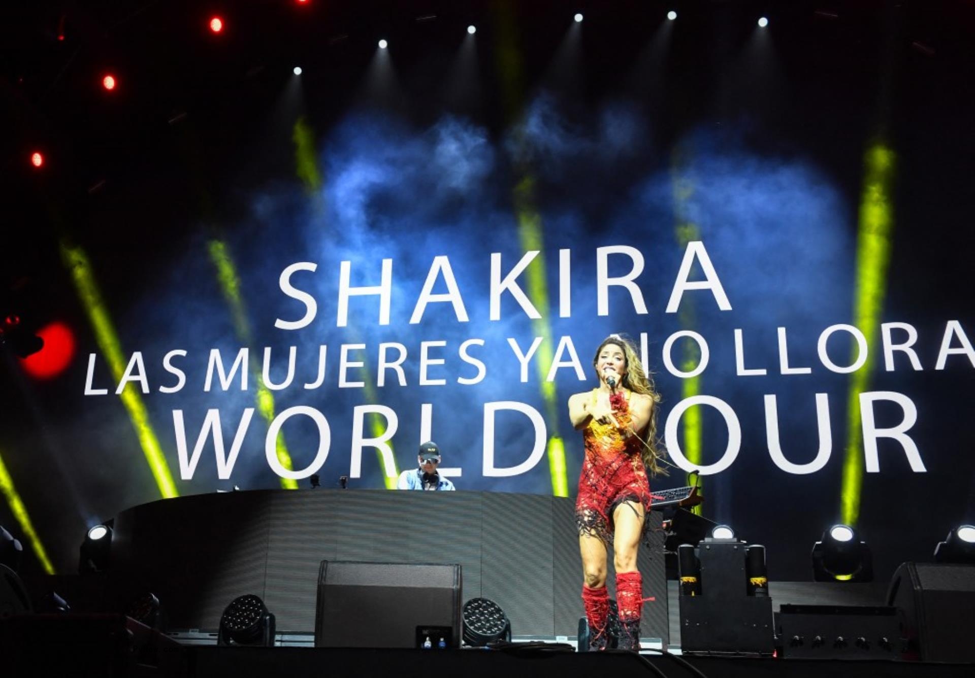 Shakira on stage during Coachella in front of sign saying:
