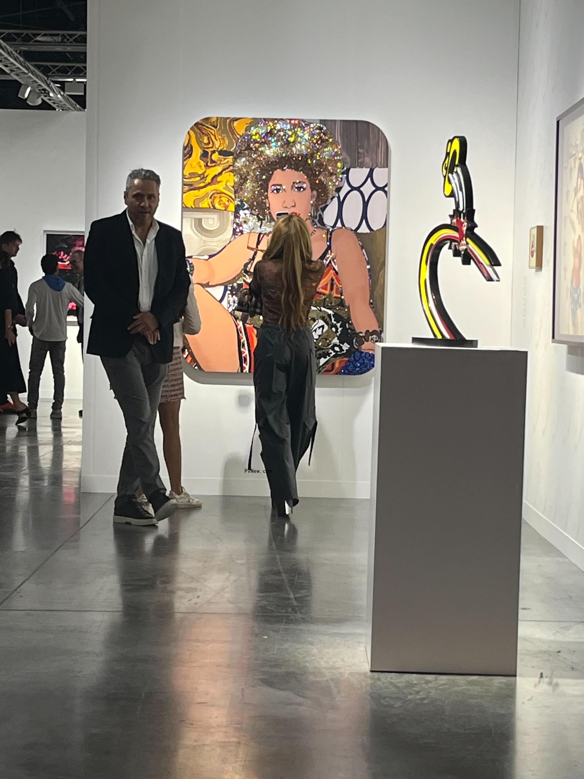 Shakira seen dressed casually and with her two children surrounded by other parents and children outside a school