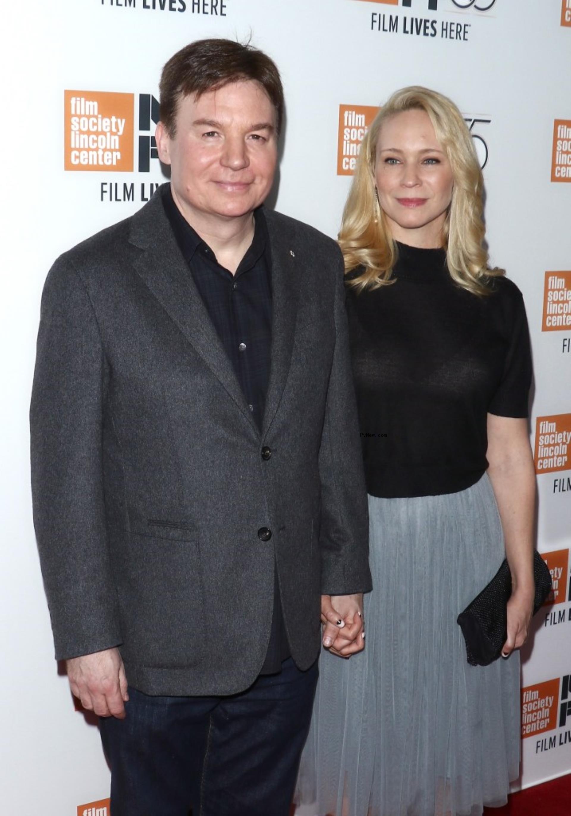 Mike Myers holding hands with his wife Kelly Tisdale.
