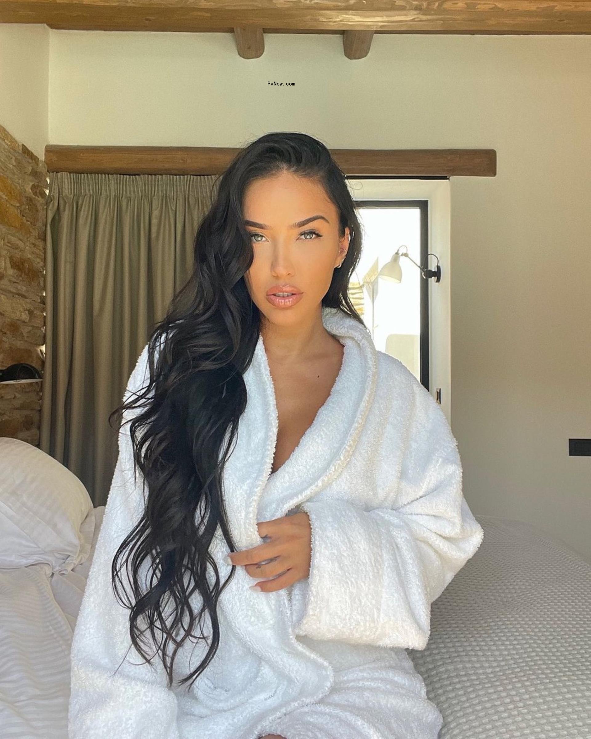Bre Tiesi in a white robe.