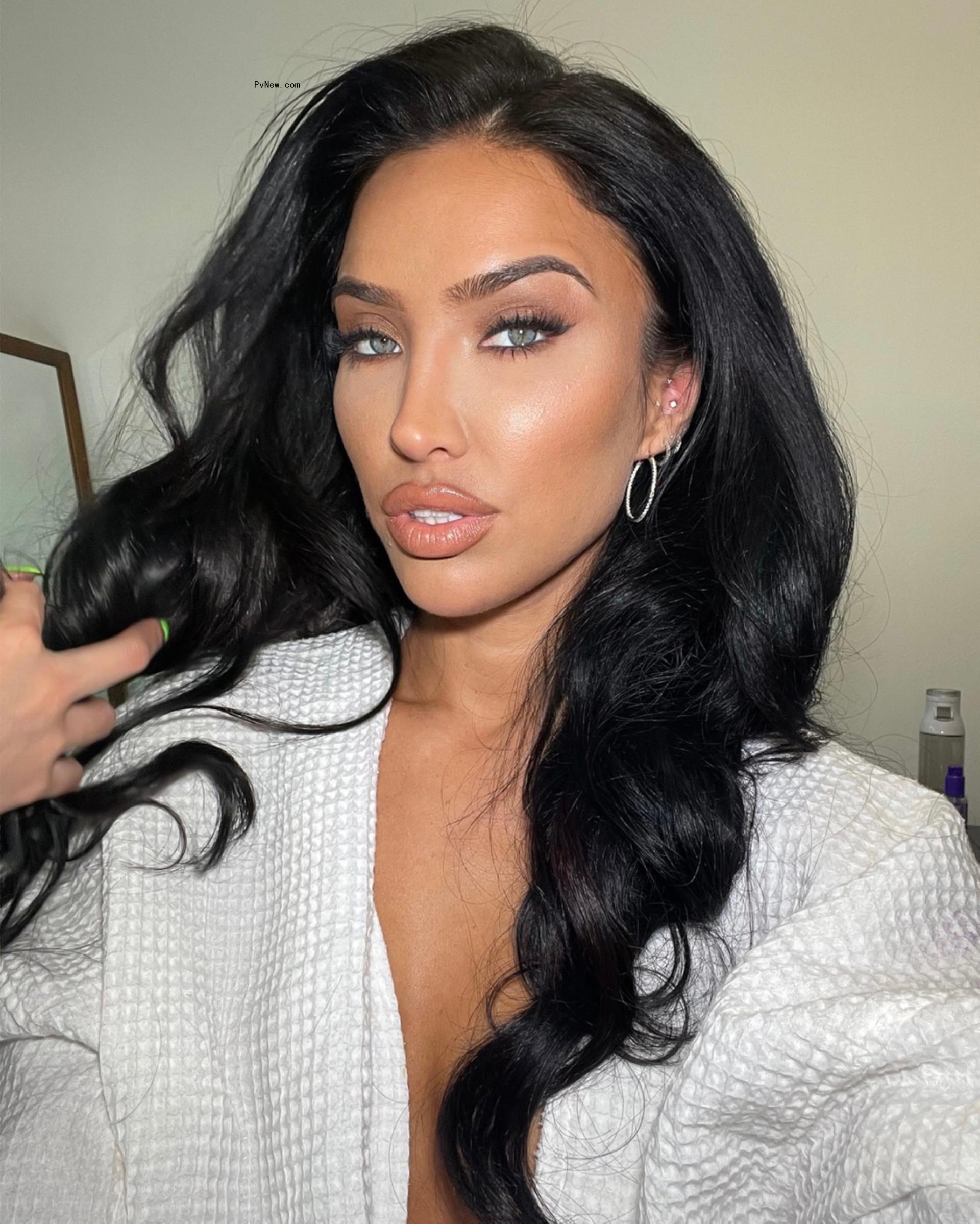 Bre Tiesi in a white robe.