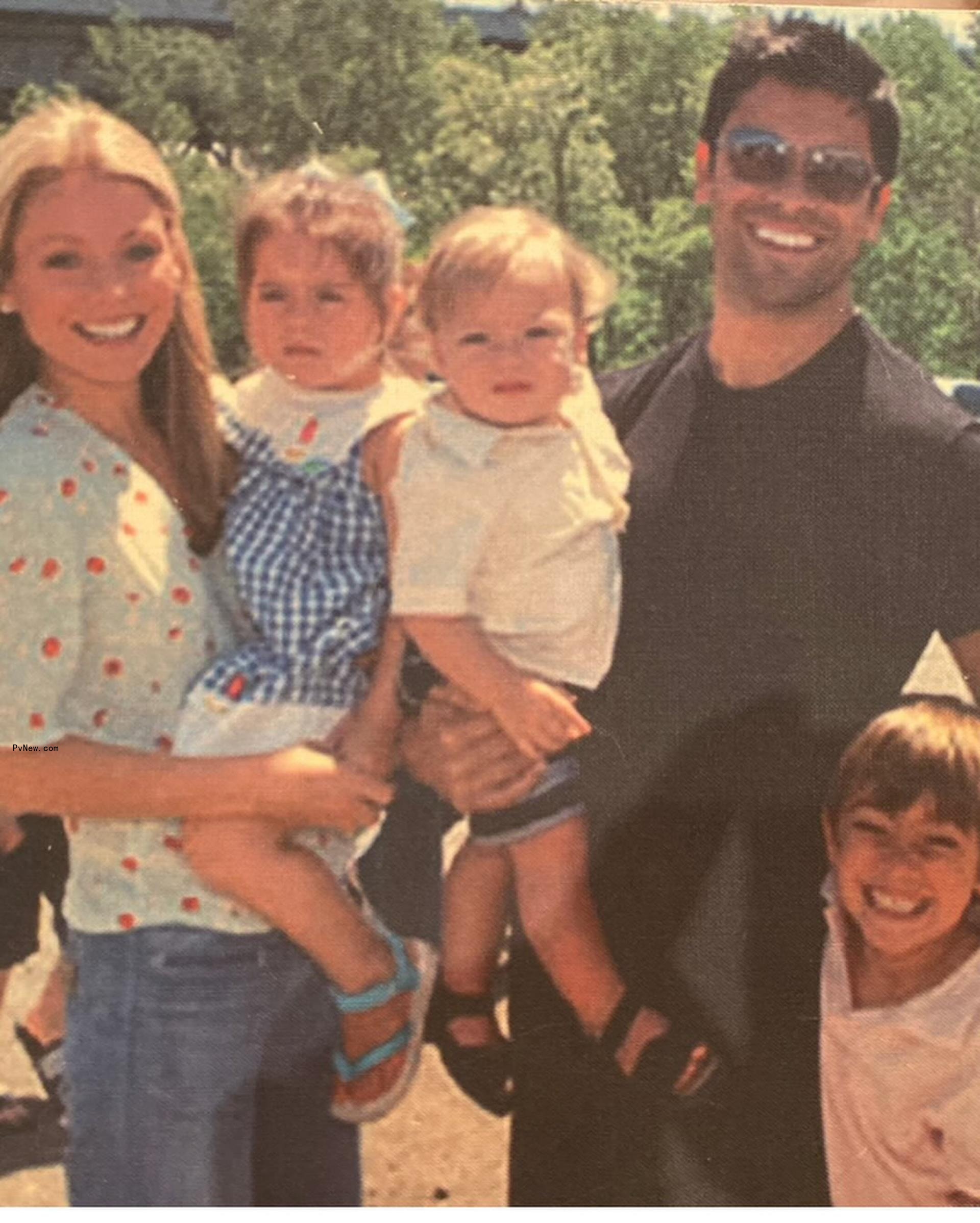 A throwback photo of Kelly Ripa and Mark Co<i></i>nsuelos posing with their kids