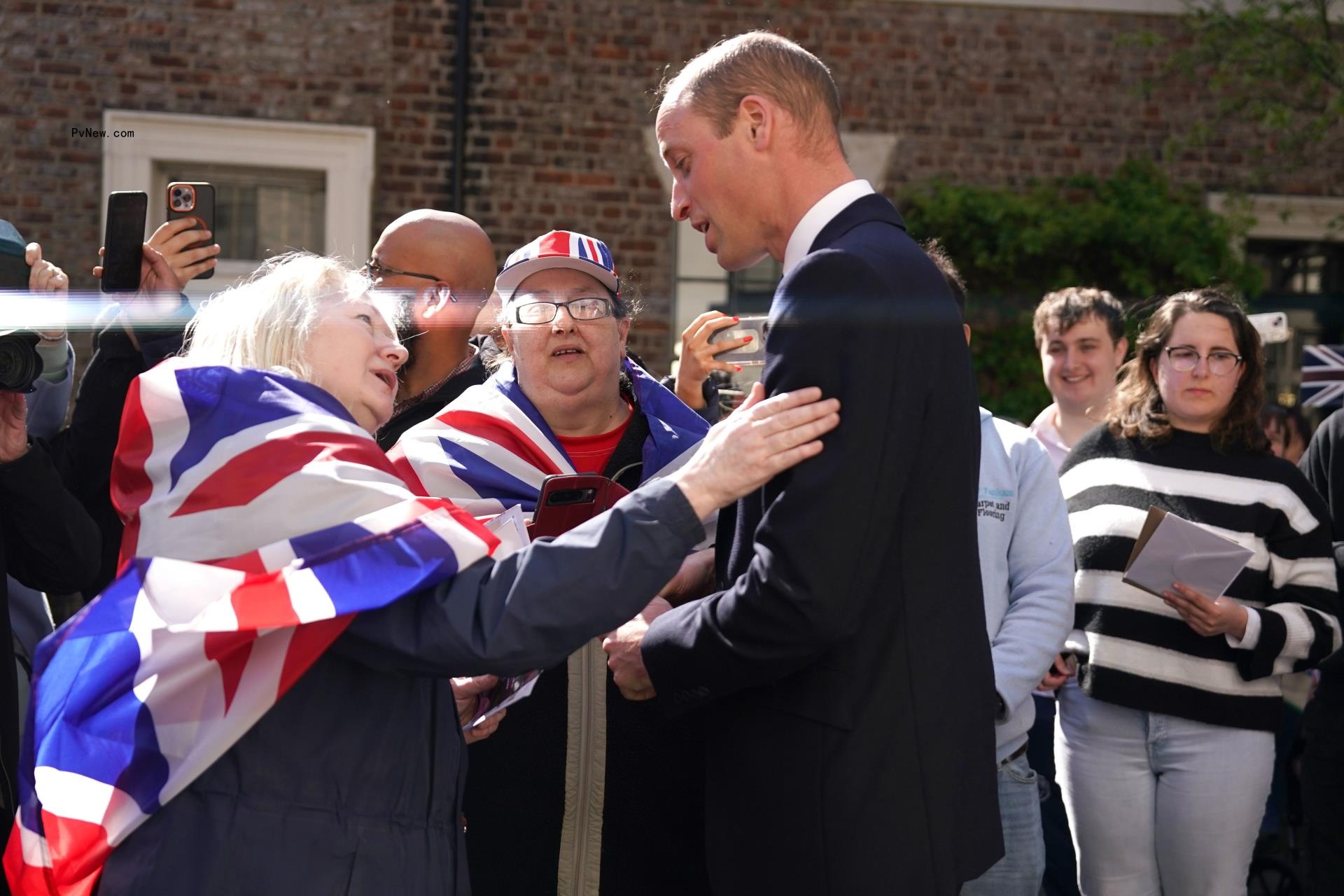 Prince Wiliam speaking to a fan.