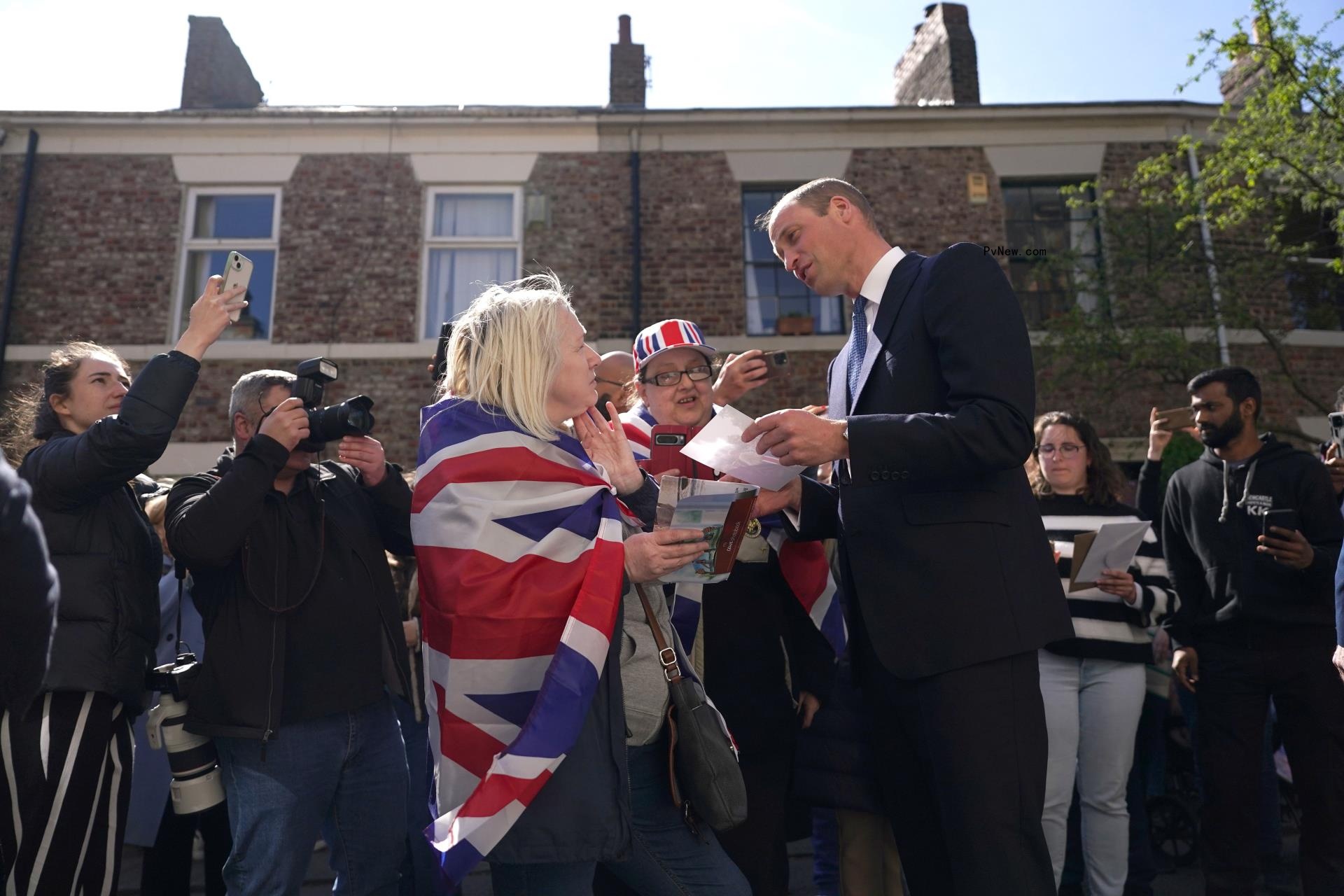 Prince William speaking to a fan.