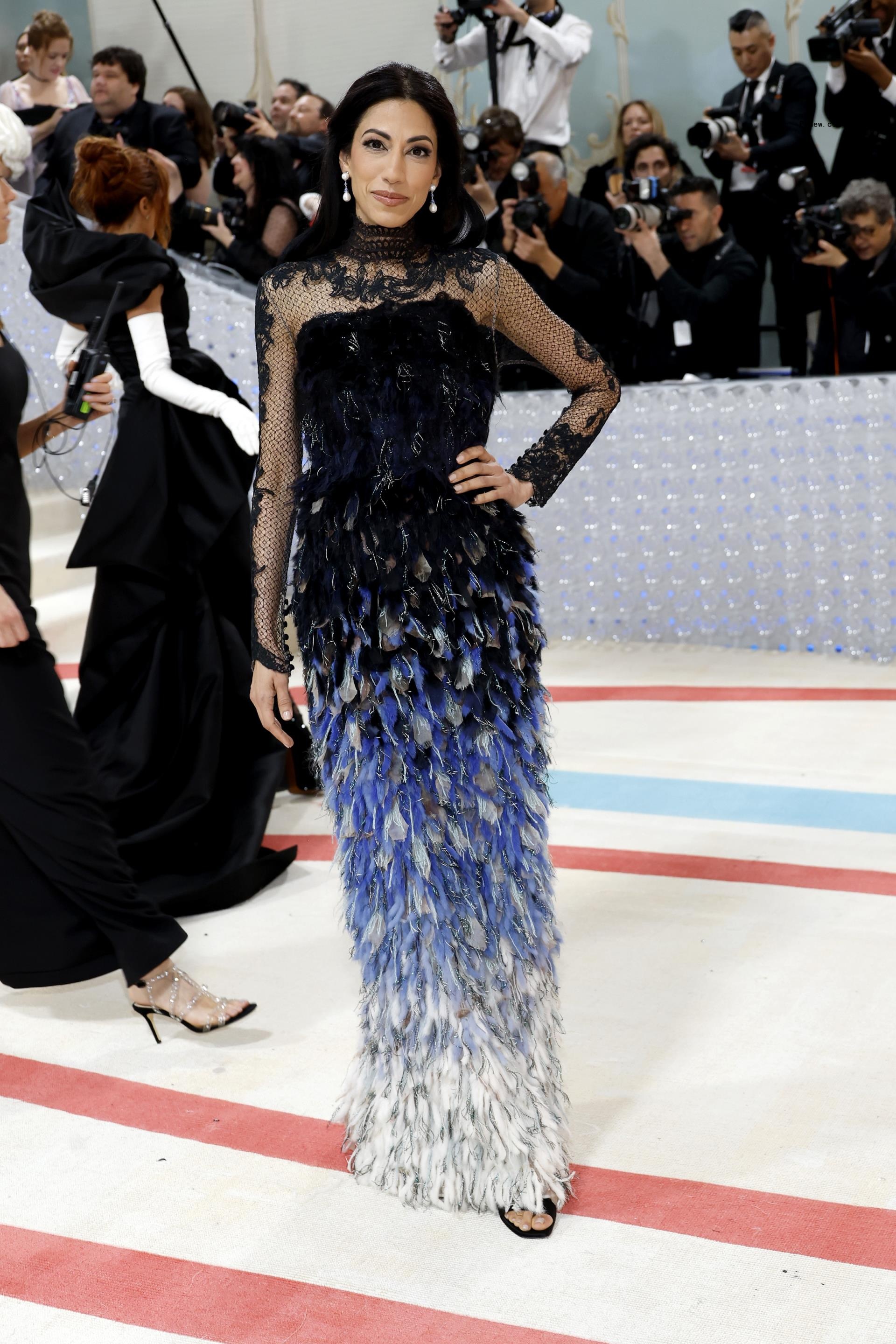Huma Abedin rests her hands on her hips on the Met Gala carpet.