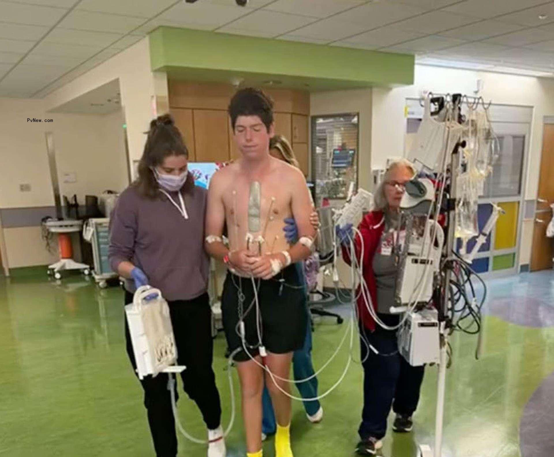 paul baier walking with nurses in hospital