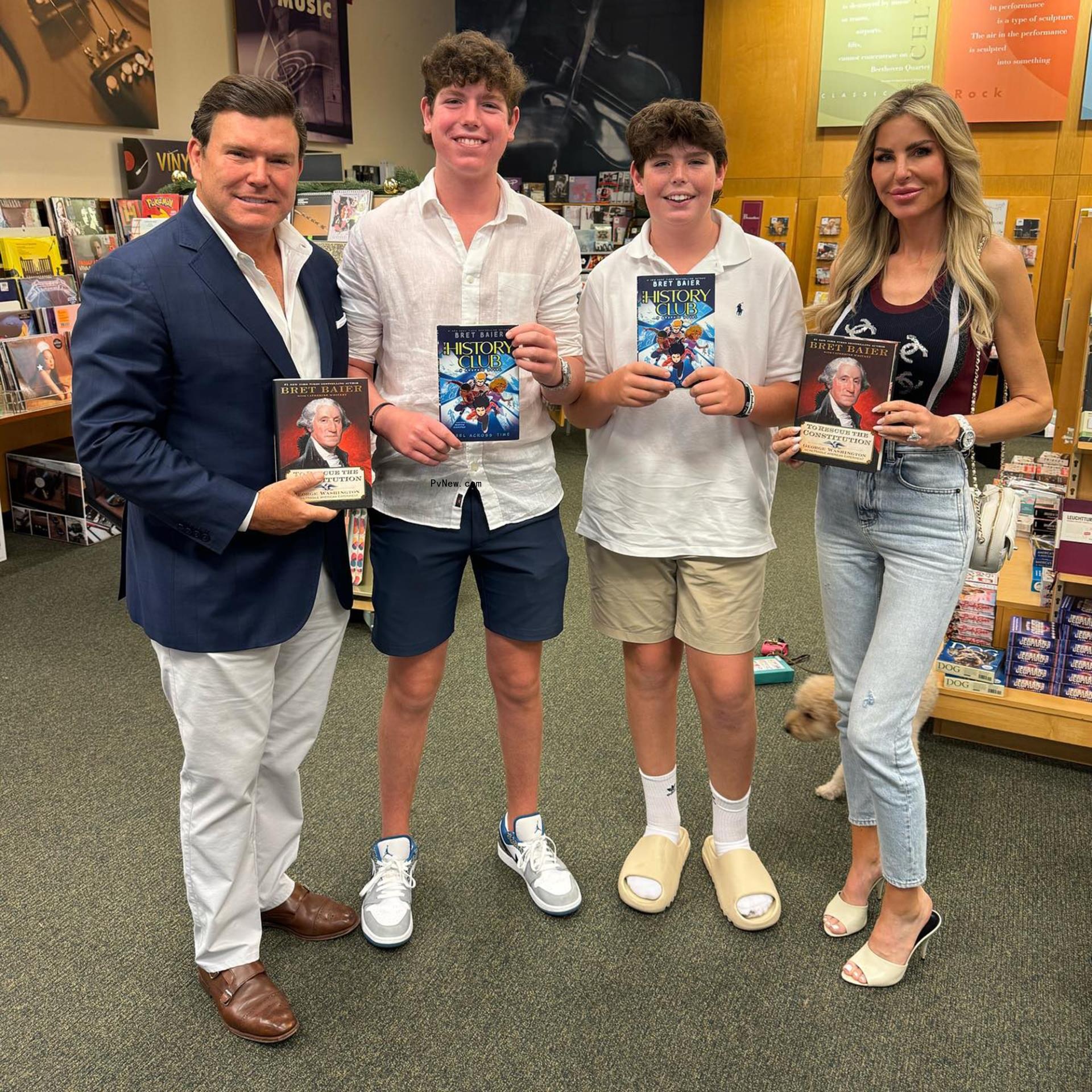 bret baier, amy baier and their two sons holding books