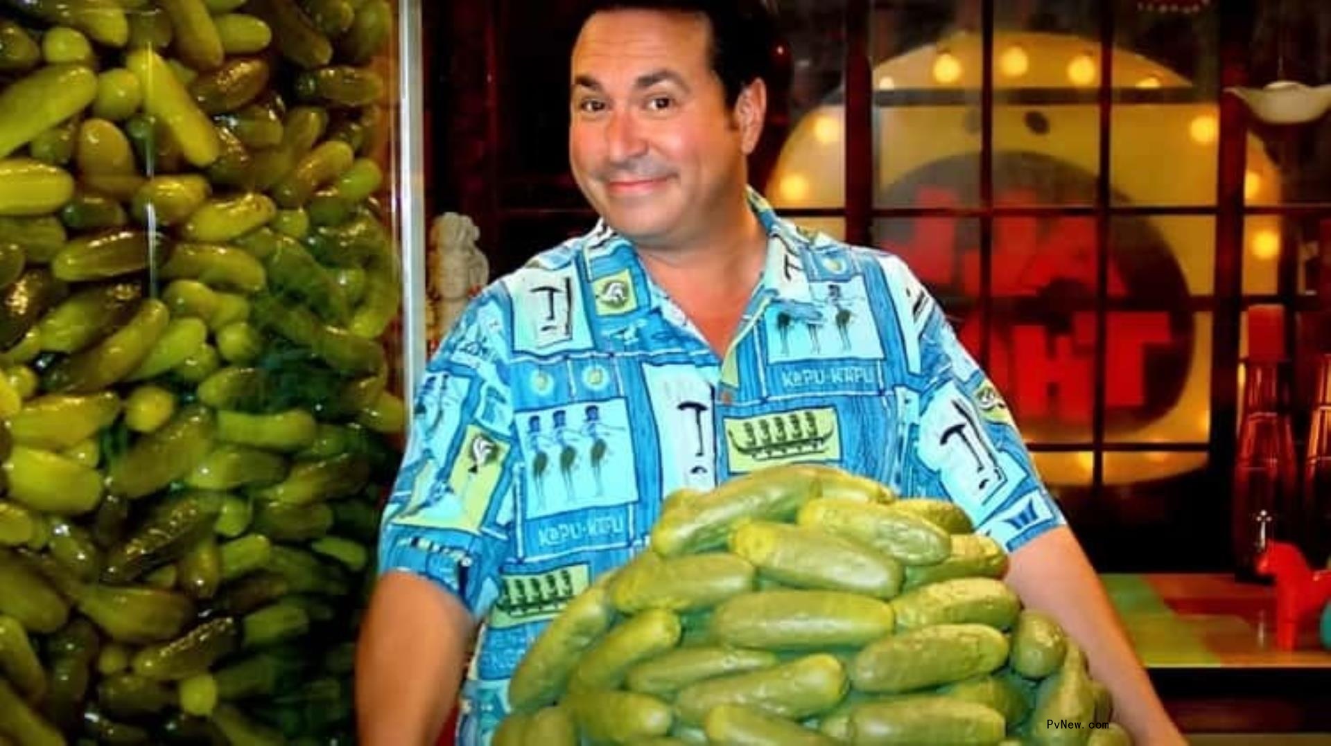 Brian Peck holding a plate of pickles.