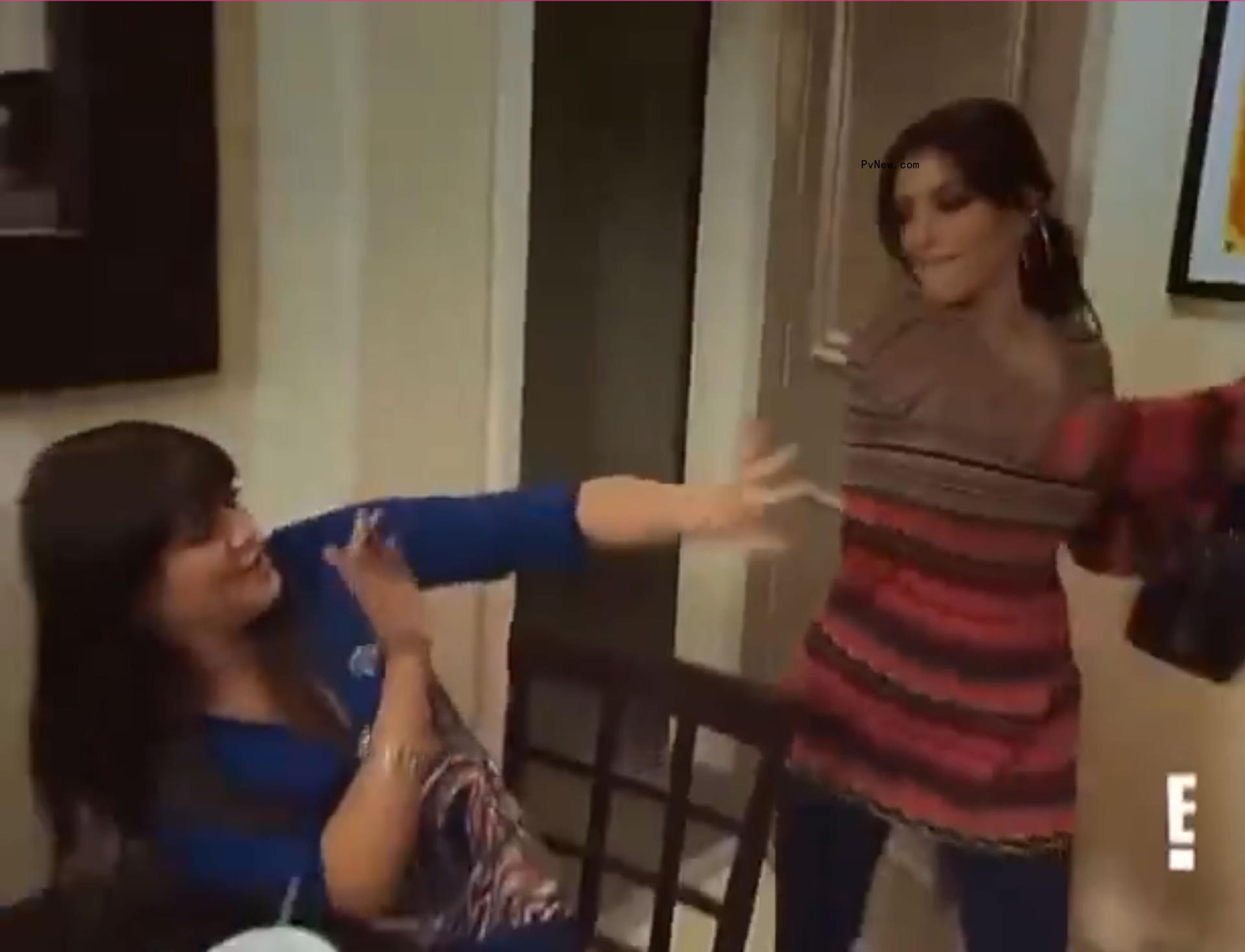 Kim Kardashian trying to hit Khloe Kardashian.