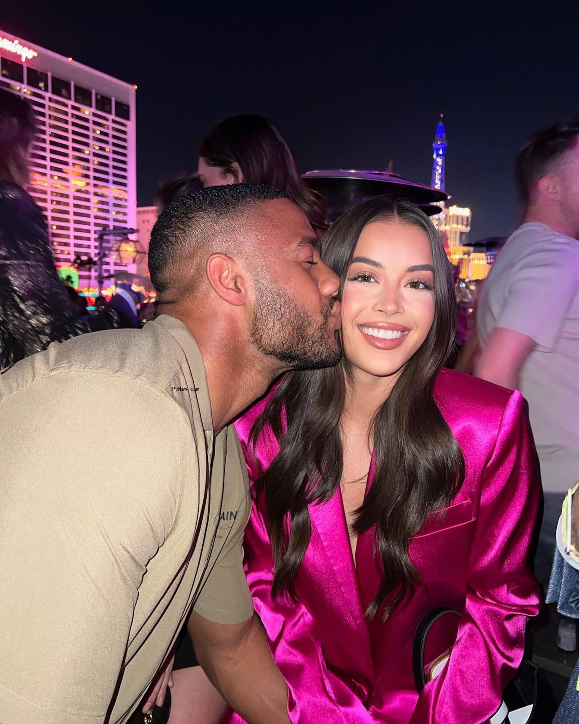 Amir Lancaster kissing Natalie Cortes on the cheek.