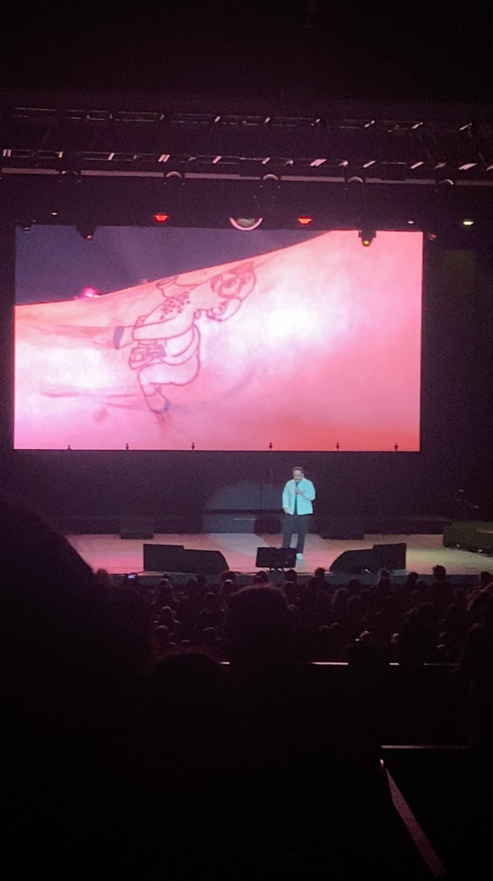 Nick Kroll showing a video of Becca Calb getting a tattoo.