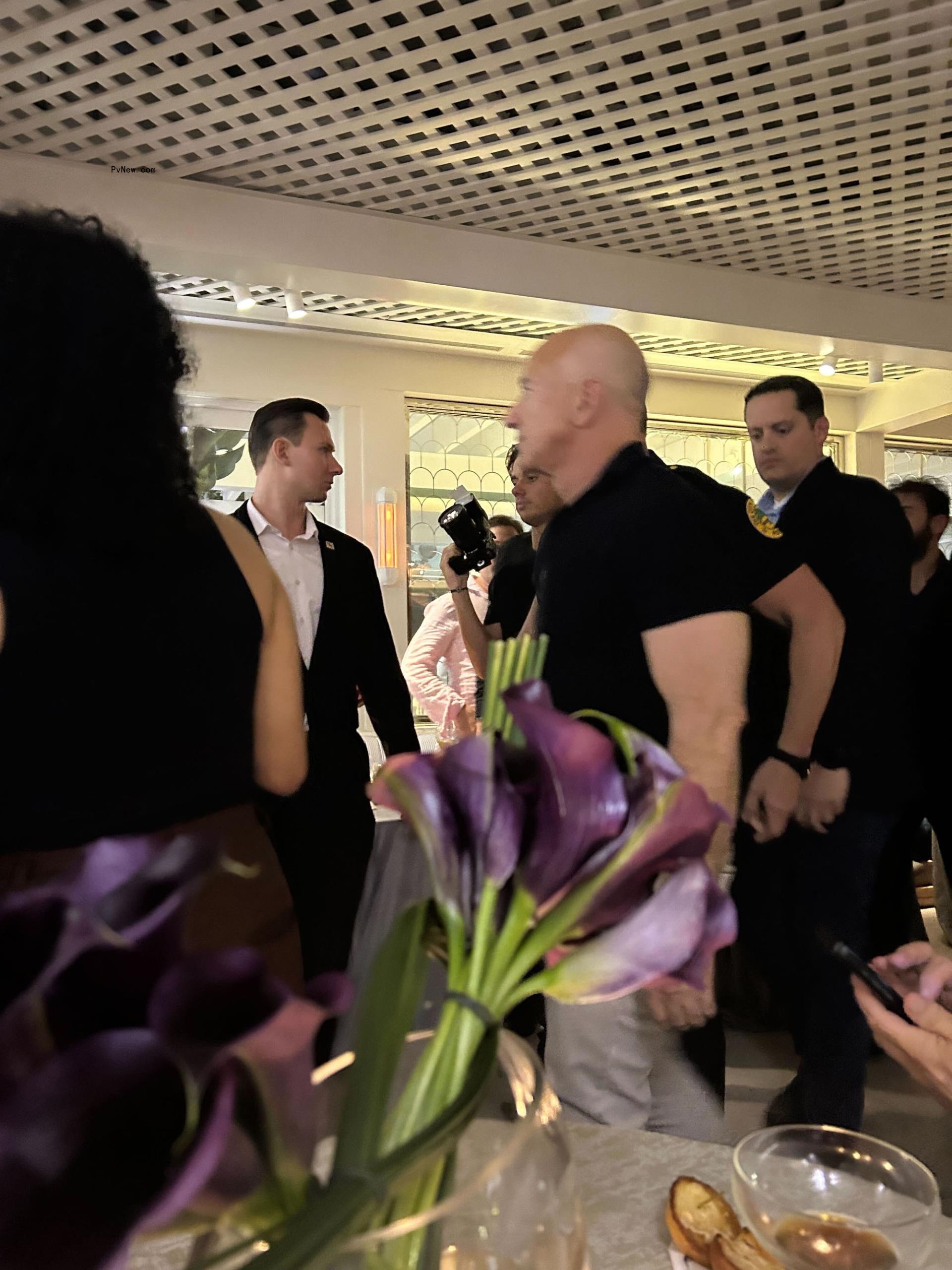 Jeff Bezos leaving a party with police beside him.