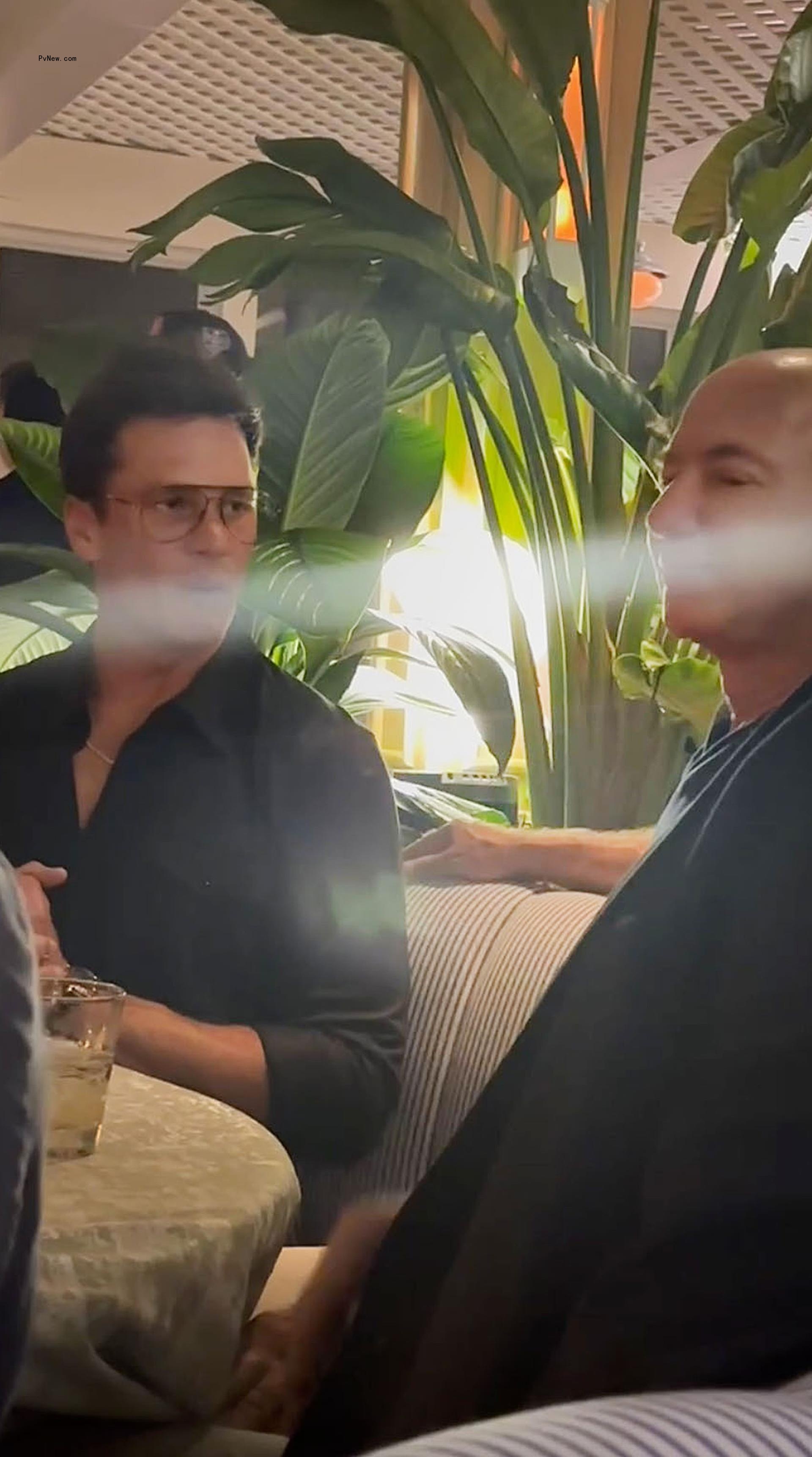 Tom Brady and Jeff Bezos chatting.