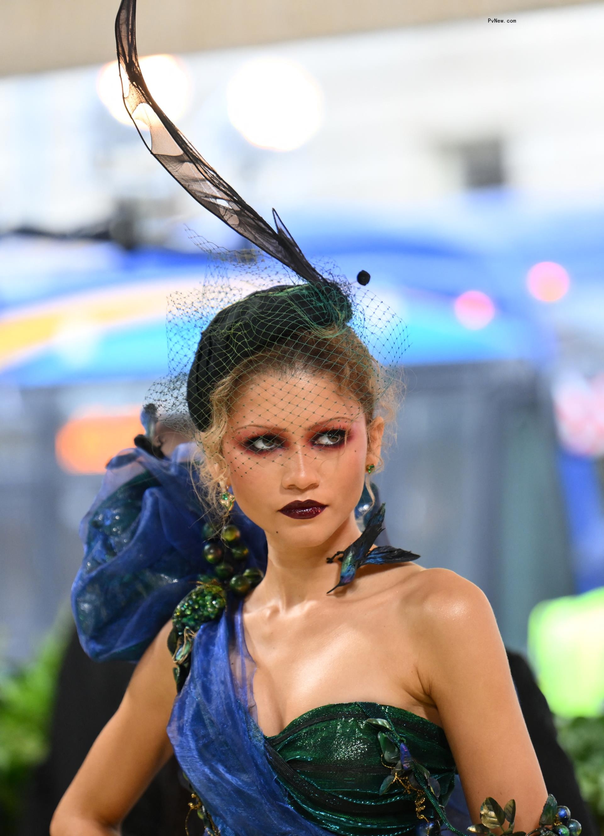 Zendaya in a feather adorned veil