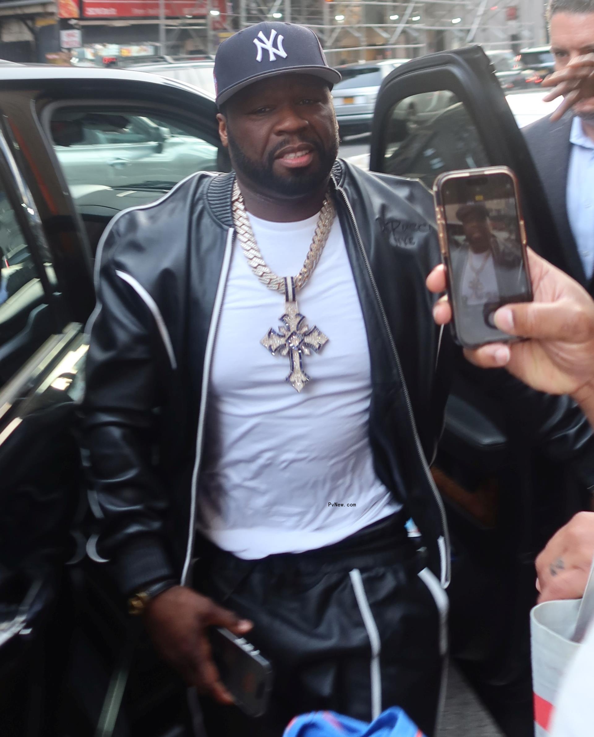 50 Cent getting out of a car.