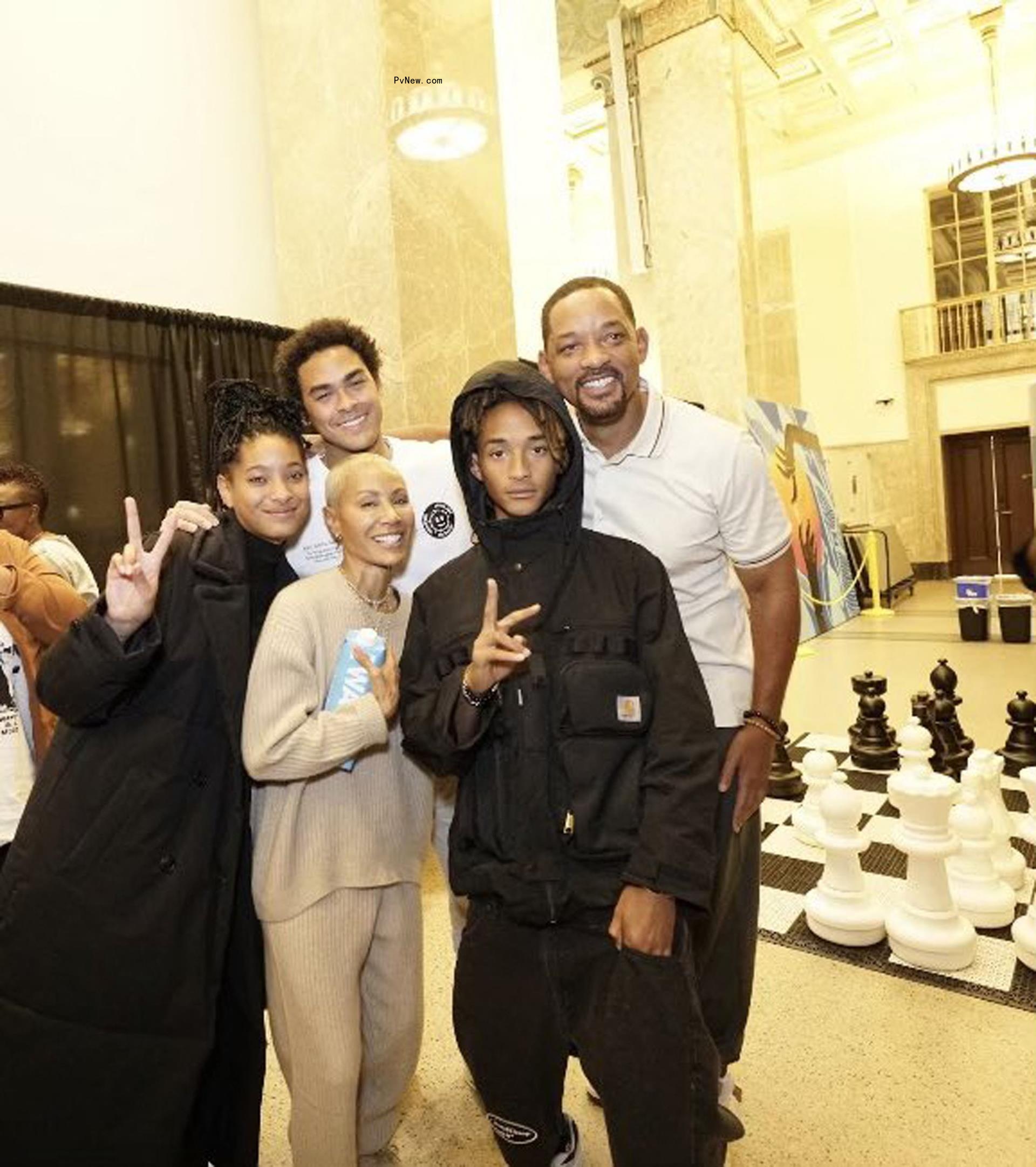 Will Smith posing with his family.