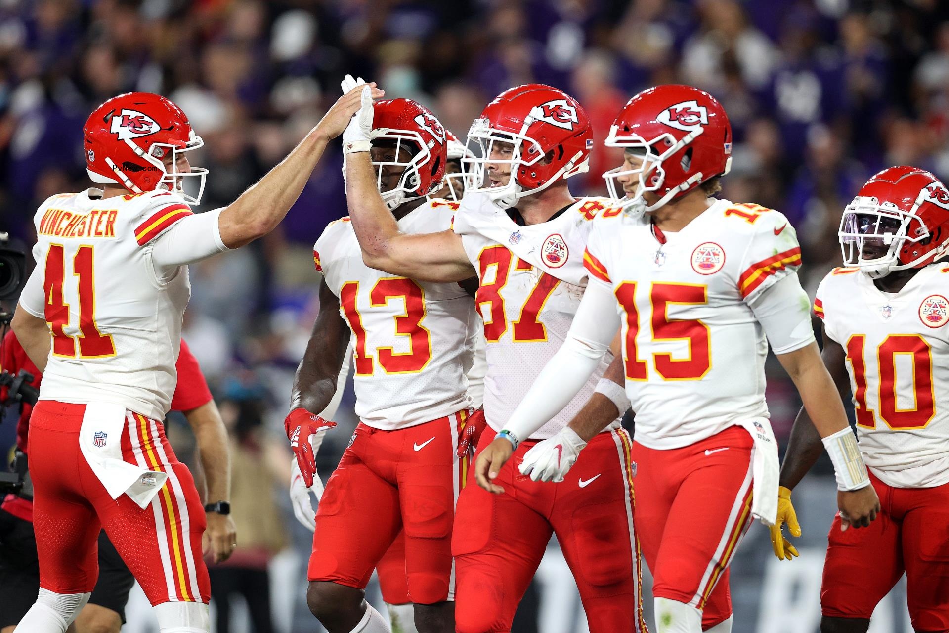 James Winchester and Travis Kelce giving each other a high five.