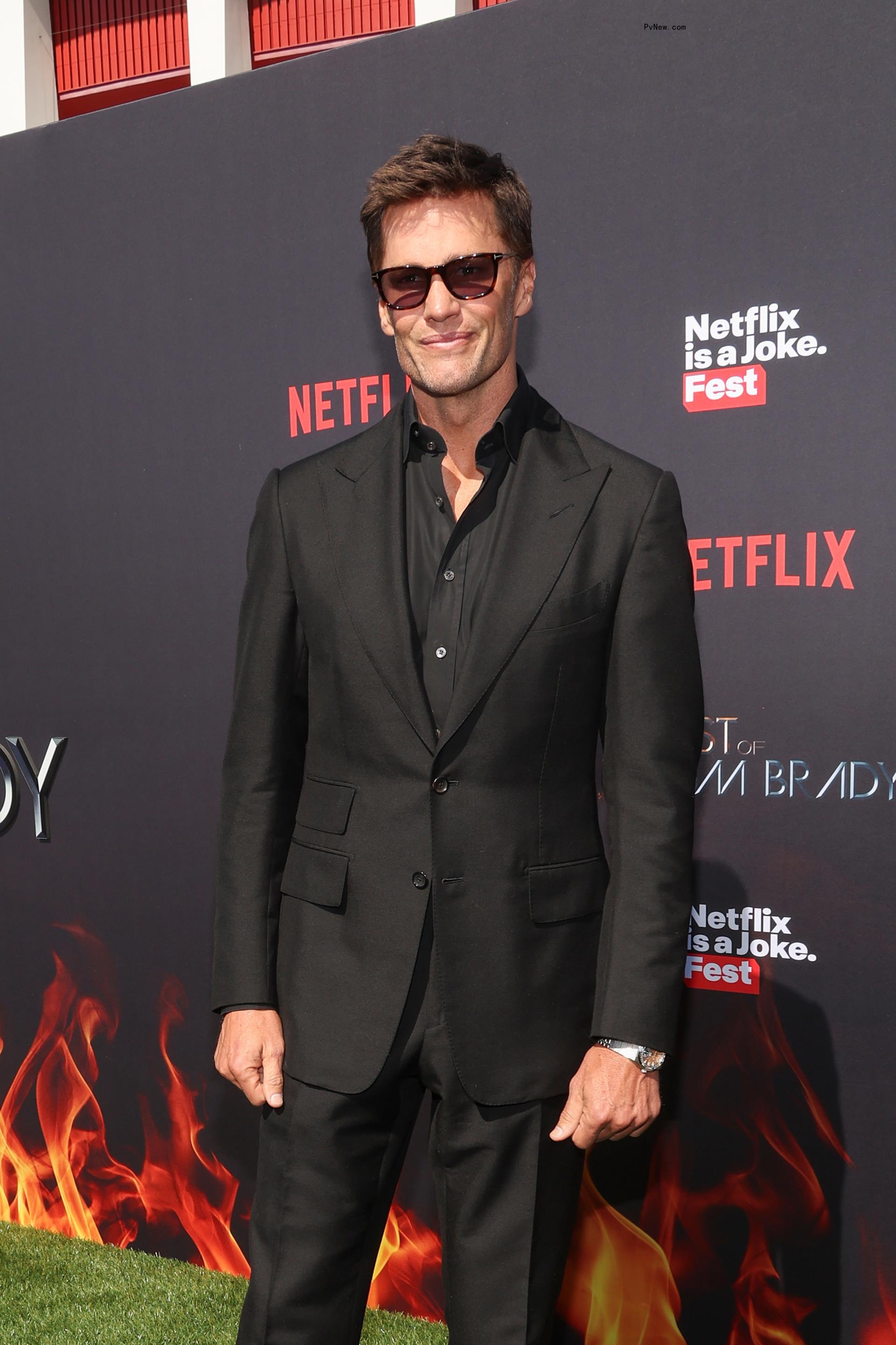 Tom Brady in a black suit.