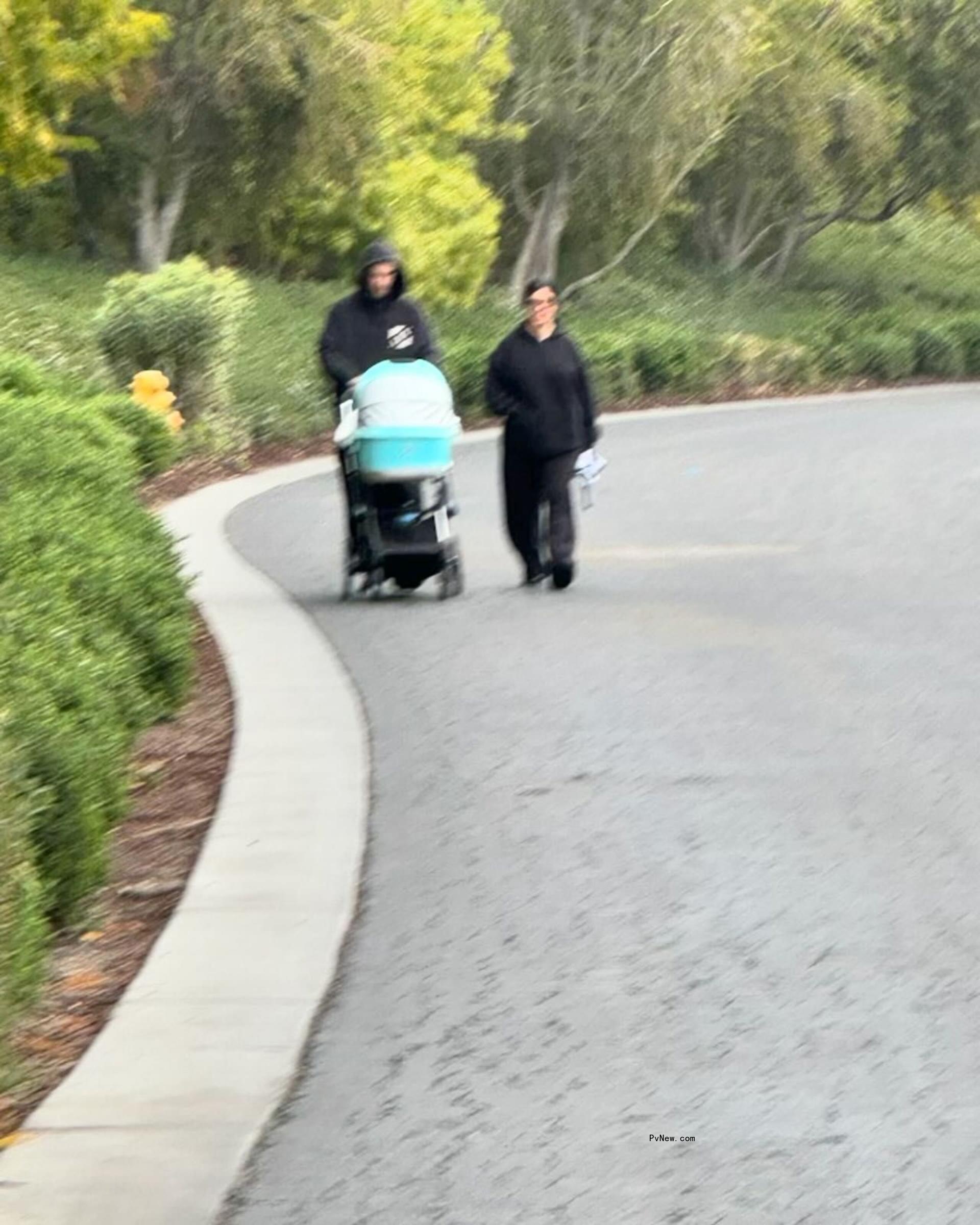 Travis Barker and Kourtney Kardashian walking with Rocky