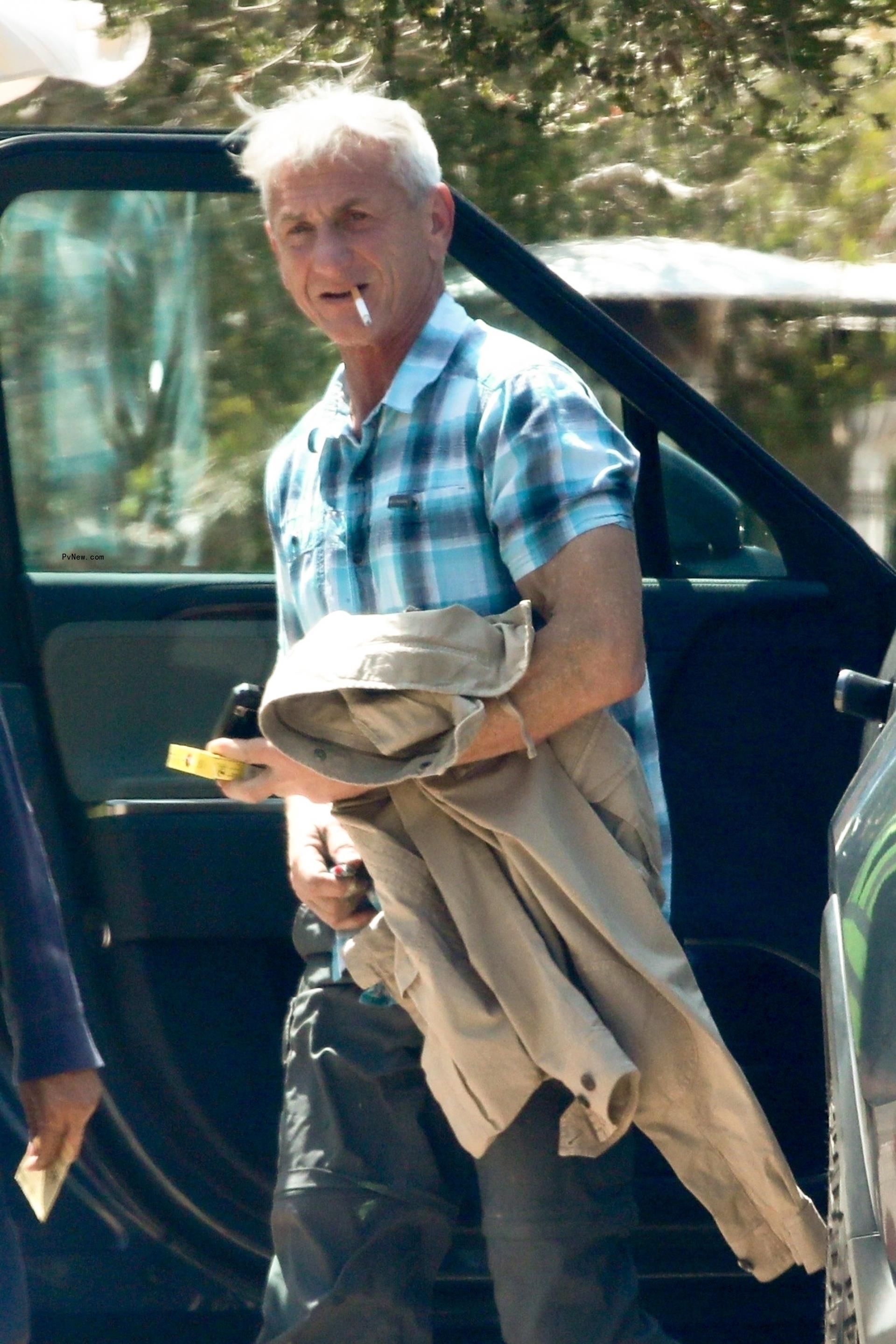Sean Penn with a cigarette in his mouth.