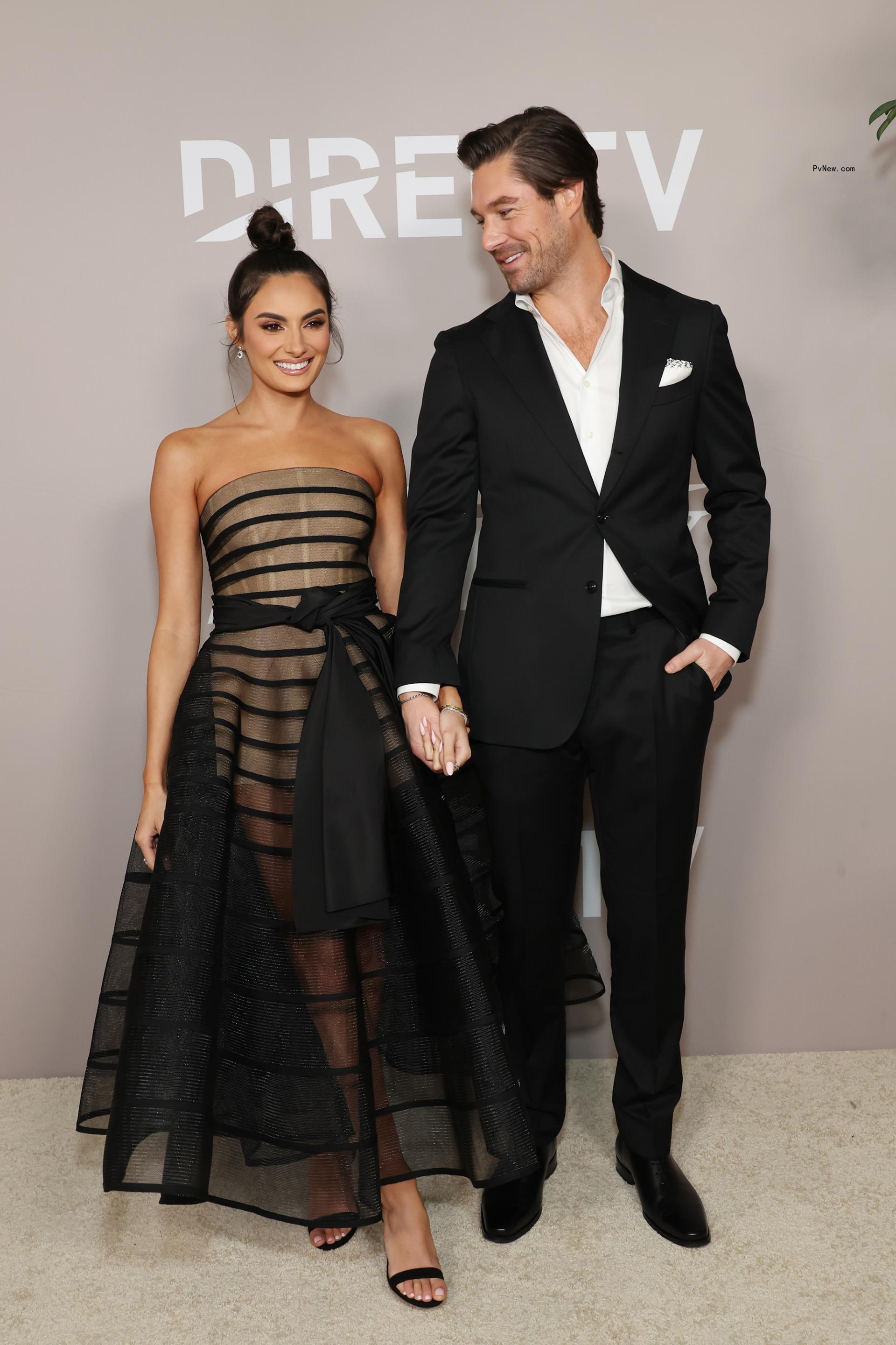 Paige DeSorbo and Craig Co<i></i>nover posing on a carpet