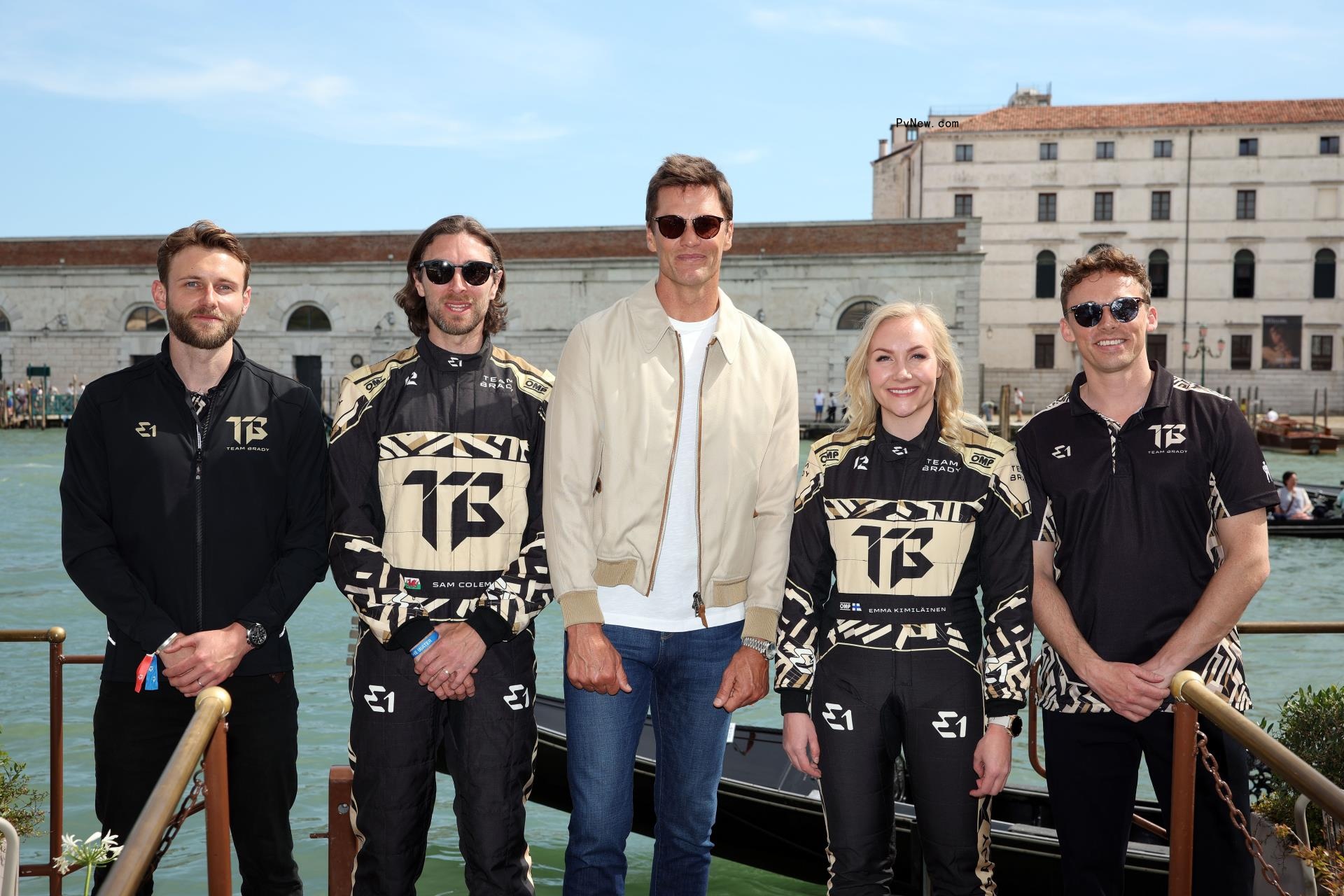 Tom Brady and his racing team posing for a photo.