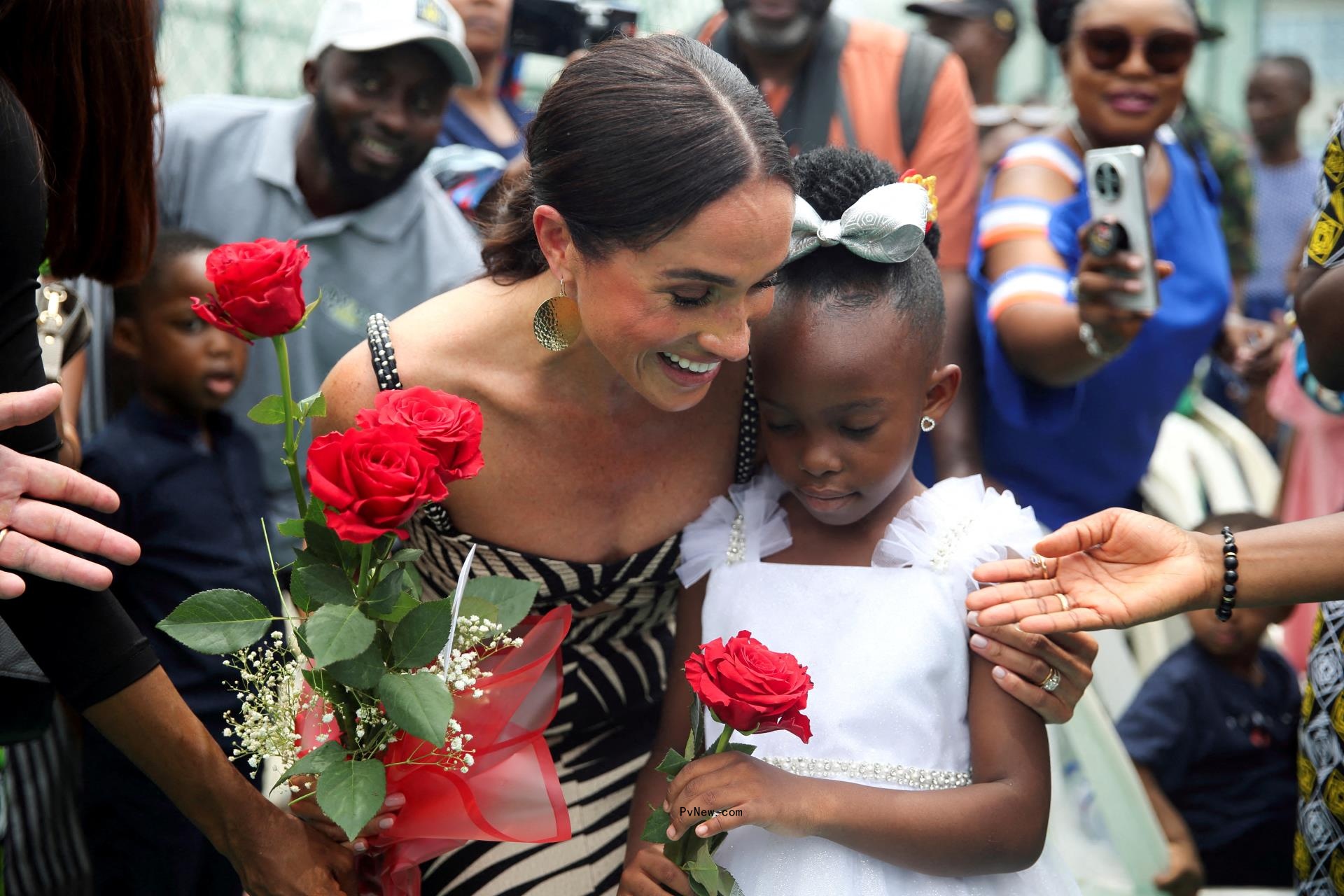 Meghan Markle with a little girl.