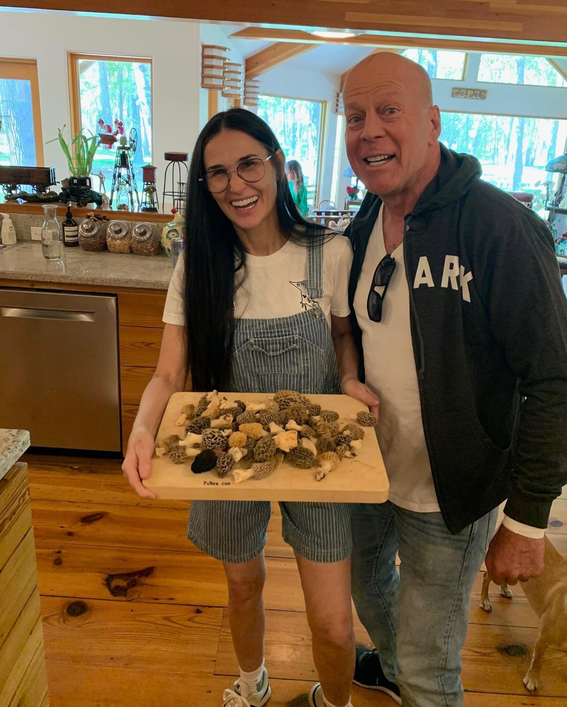 Bruce Willis and Demi Moore celebrating Bruce's birthday, holding a cutting board