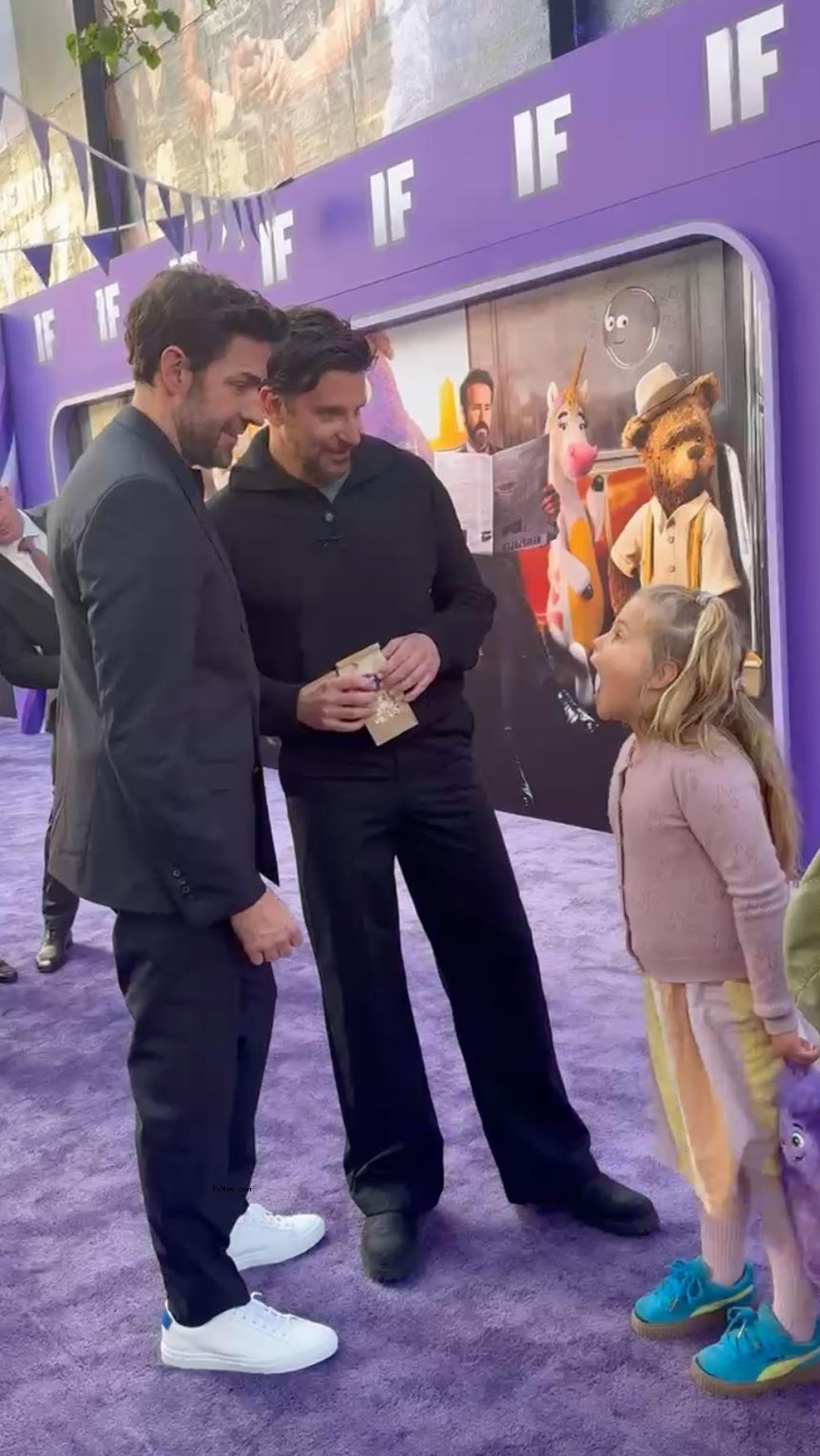 John Krasinski talking to Bradley Cooper's daughter, Lea, at the 