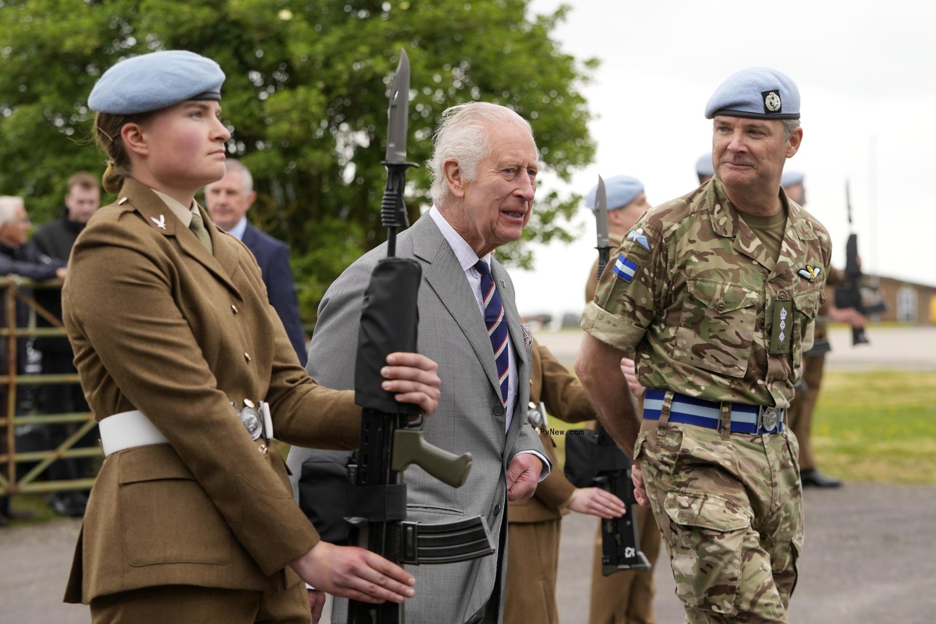King Charles talking with military members