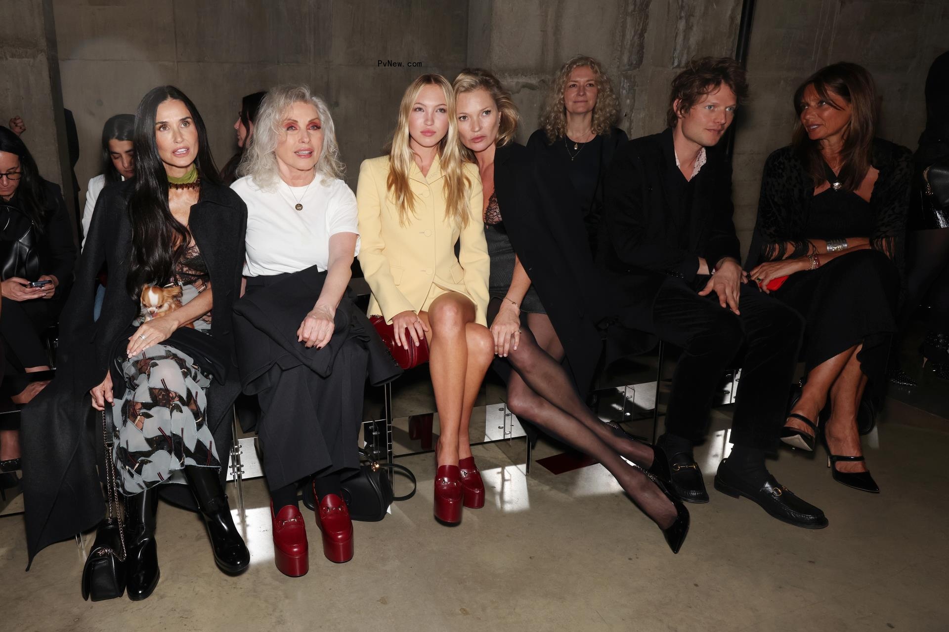 Demi Moore and her dog Pilaf with Debbie Harry, Lila Moss, and Kate Moss at  the Gucci Cruise 2025 fashion show