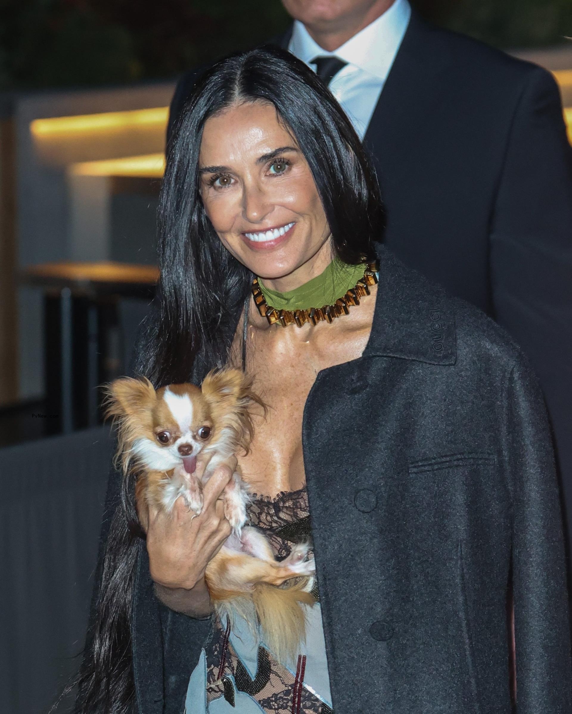 Demi Moore and her dog Pilaf at the Gucci Cruise 2025 fashion show