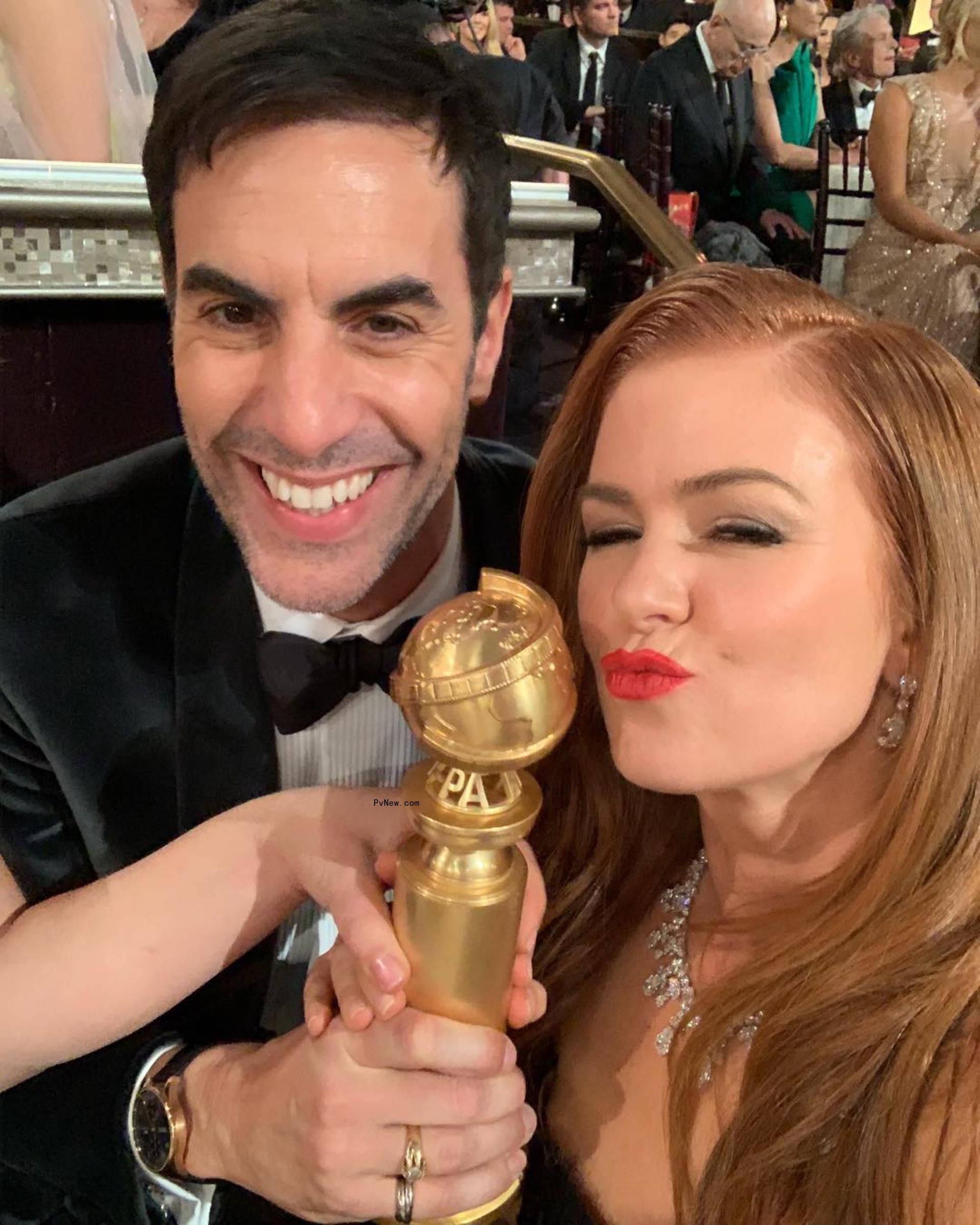 Isla Fisher and Sacha Baron Cohen at an award show.