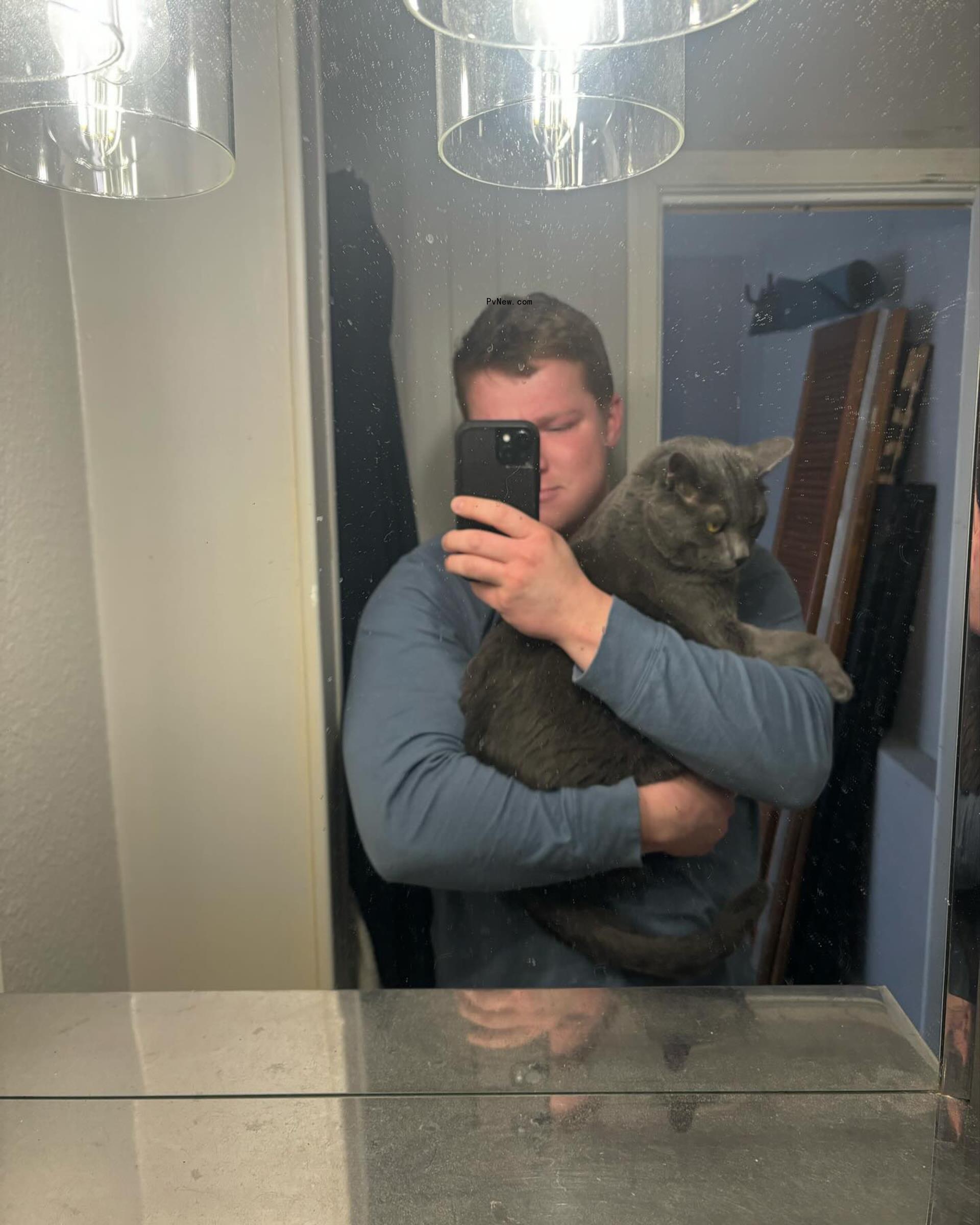 Garrison Brown holding a cat.