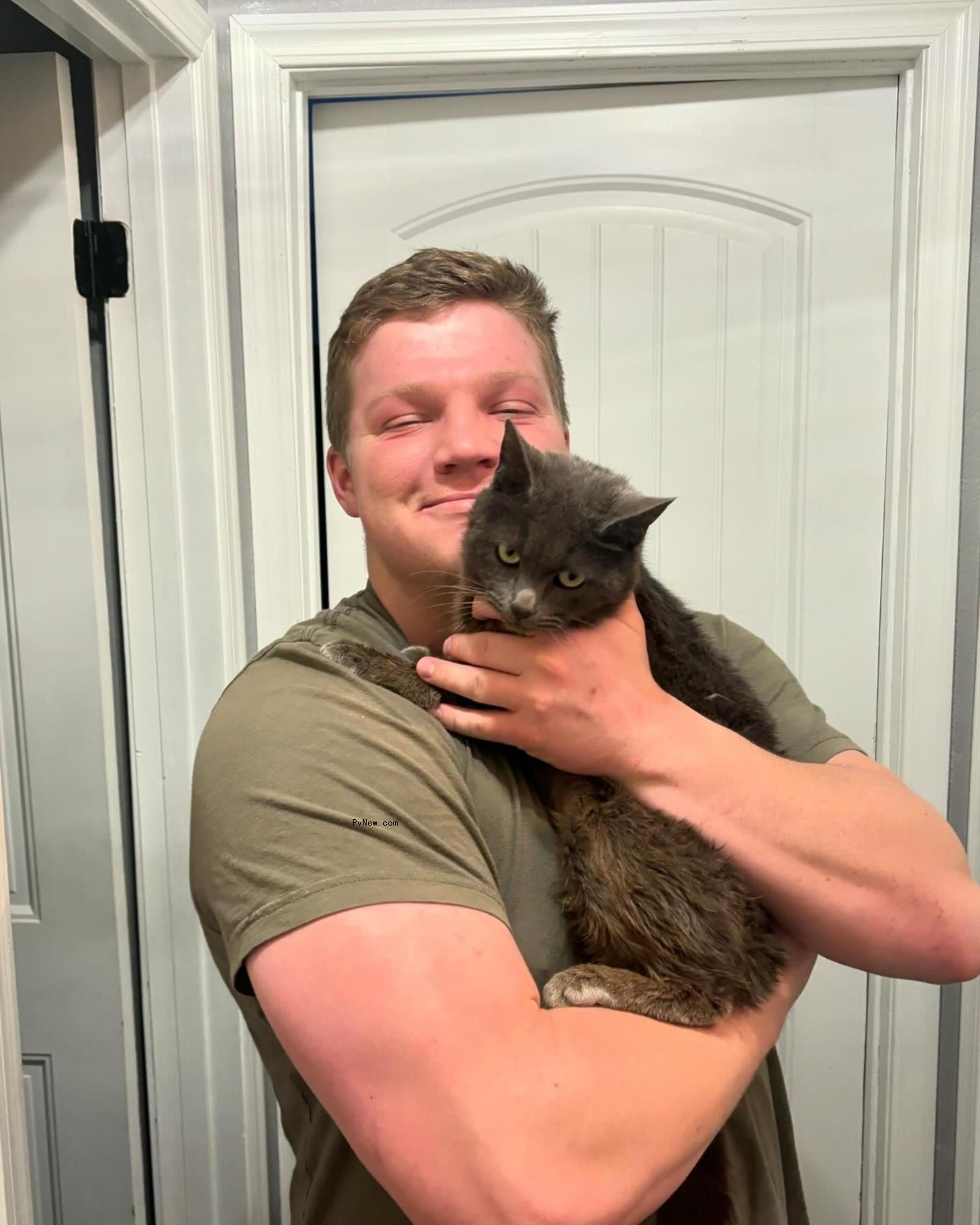 Garrison Brown holding a cat.