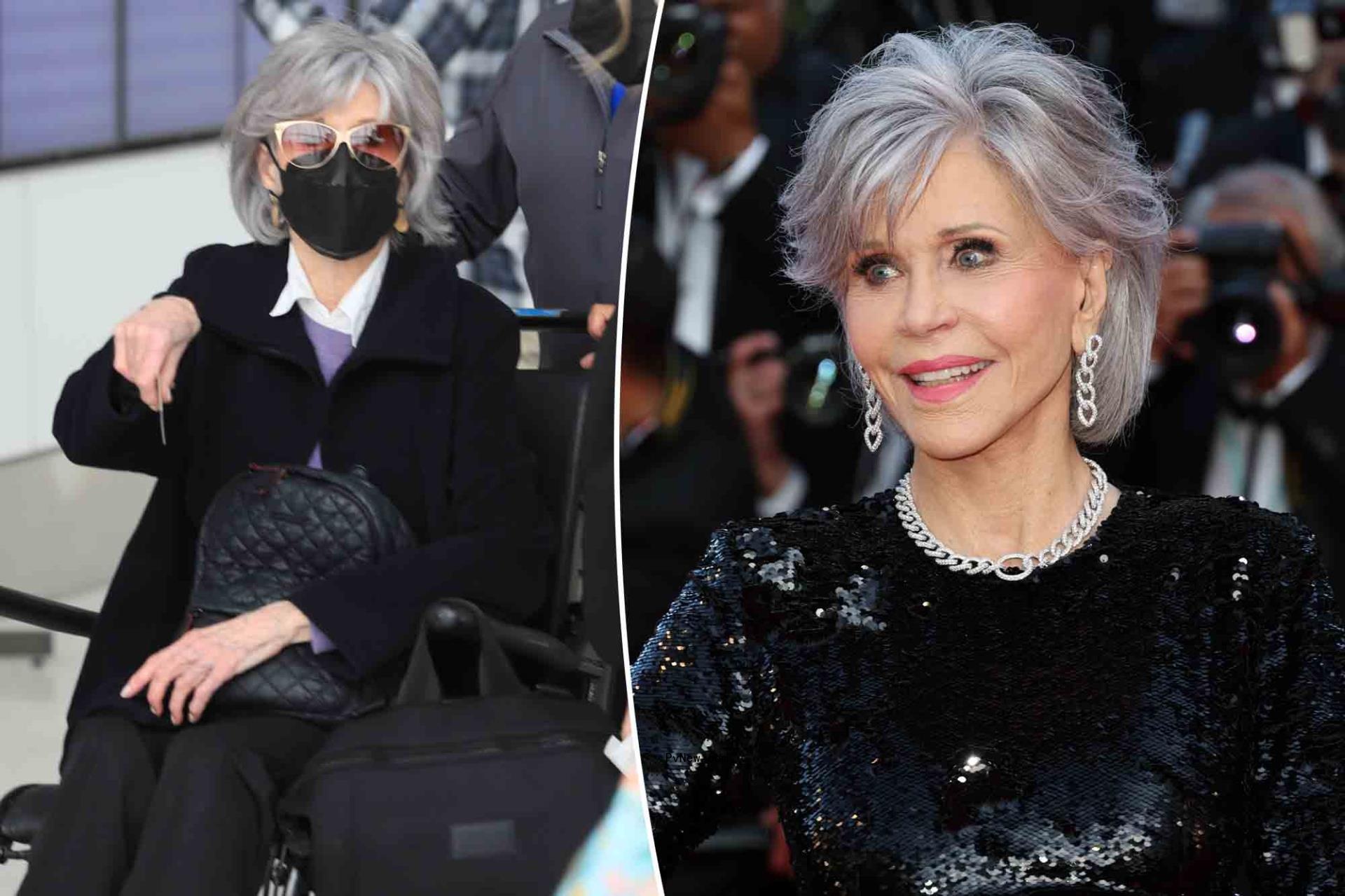 Jane Fo<i></i>nda gets pushed in wheelchair through airport.