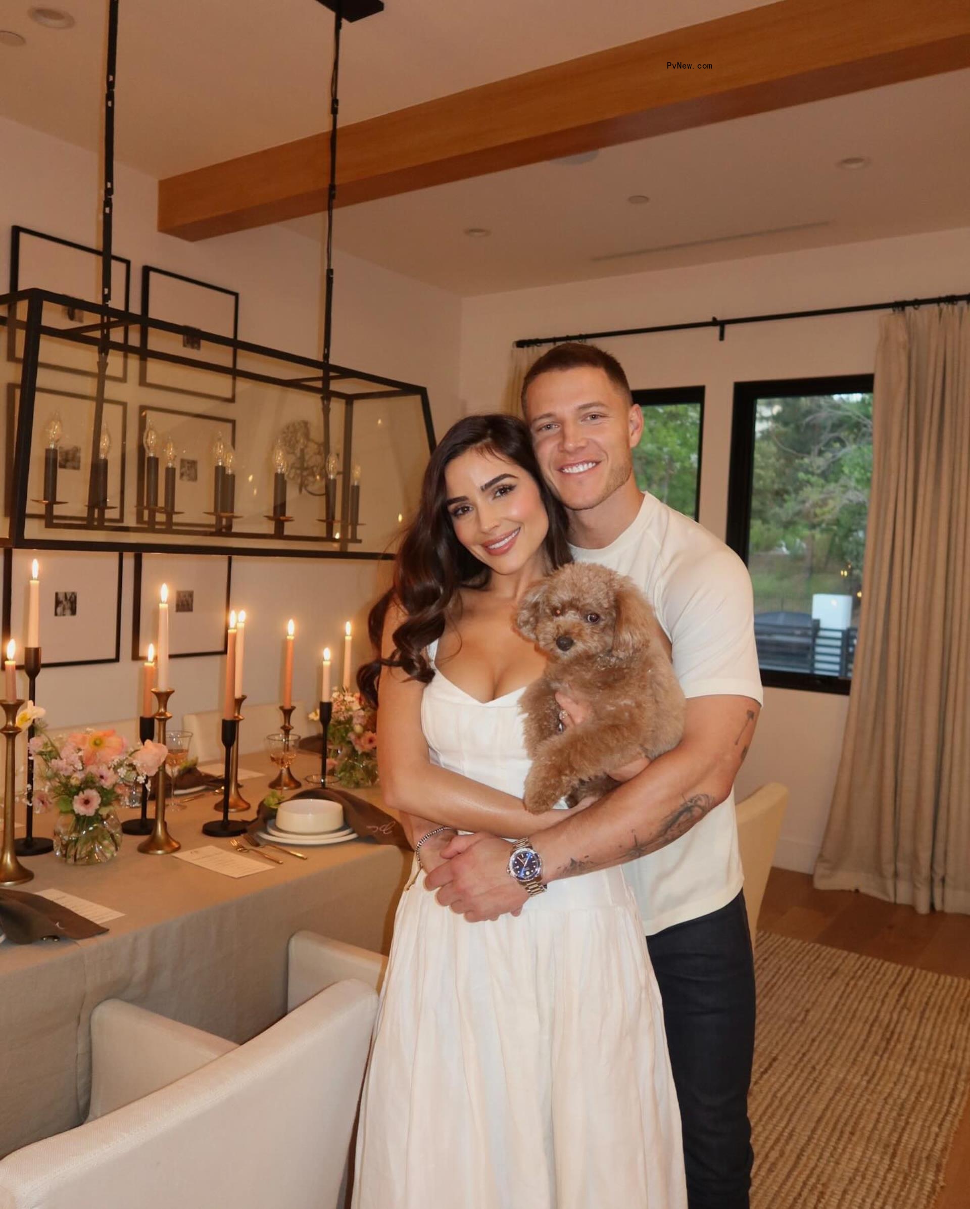 Olivia Culpo and Christian McCaffrey with their dog.